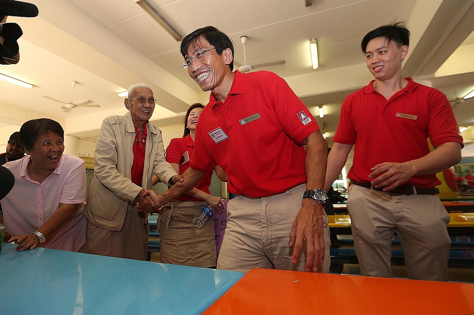 Dr Chee (centre) after a press conference yesterday at Keming Primary School, the nomination centre. Earlier, he said that SDP will make Bukit Batok a model town and "the envy of Singapore". At the conference, he said that apart from rallies, he will