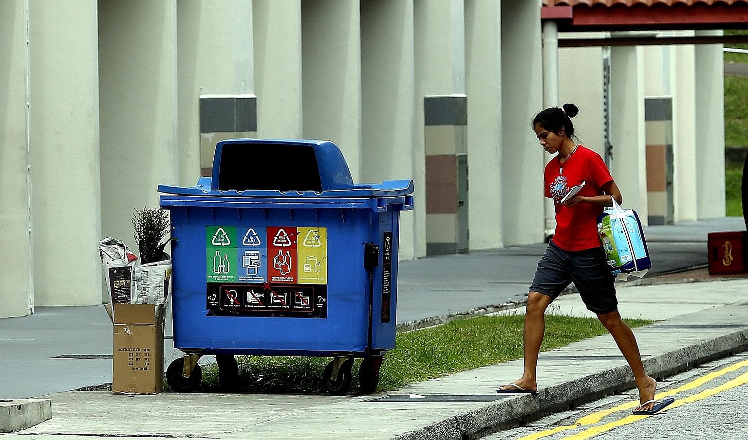 Since September 2014, every HDB block has had a blue recycling bin, in which people put paper, plastics and other recyclables, placed nearby.