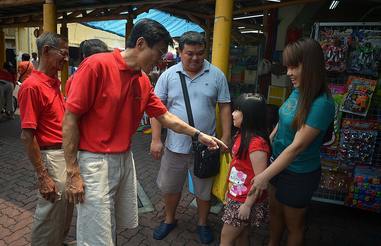 Dr Chee meeting residents at the foot of Block 154, Bukit Batok West Avenue 8, yesterday. He said he wanted to show that full-time MPs can take care of residents a lot better.