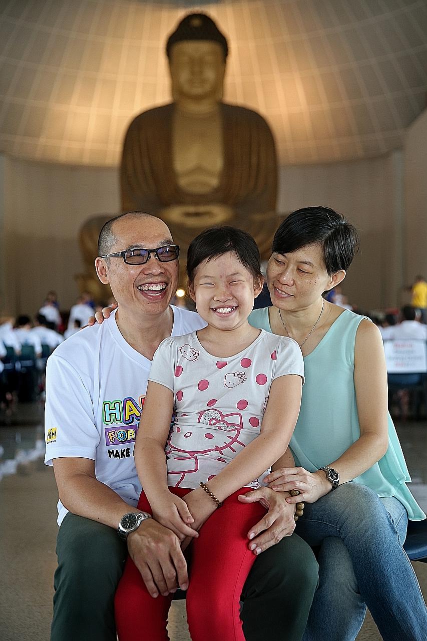 Mr Chong with his daughter Joanna and wife Pauline. Mr Chong was one of 353 participants who had their heads shaved at the Children's Cancer Foundation's Hair for Hope fund-raising event yesterday. Joanna had a tumour removed from her brain last year