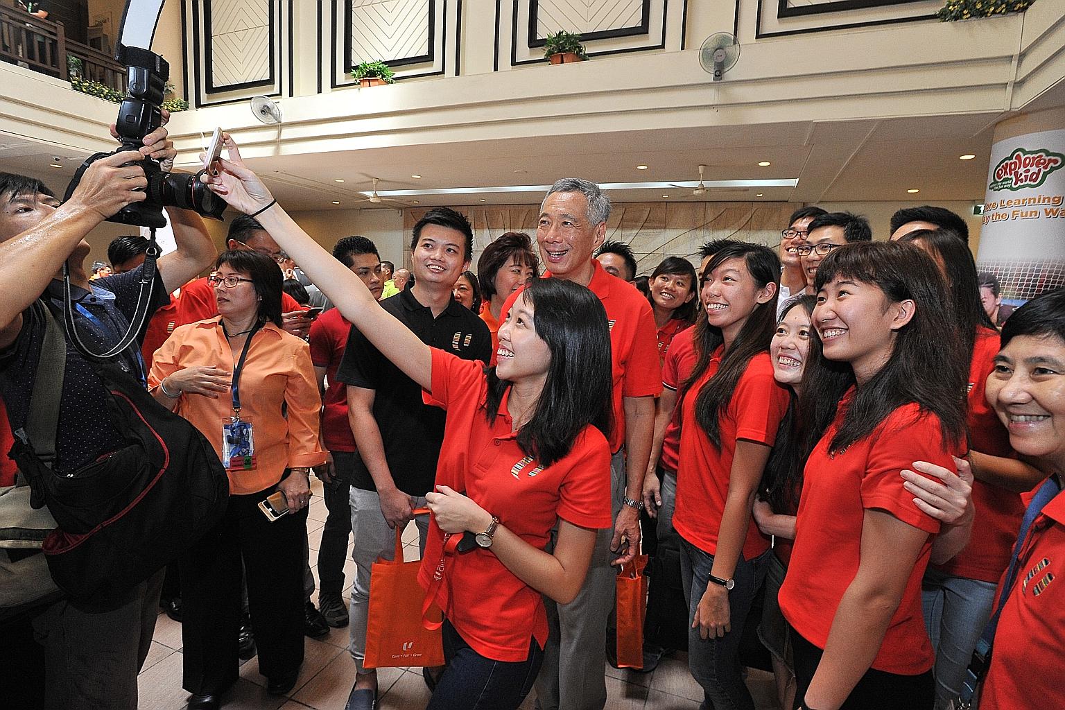 Mr Lee pausing for a wefie with participants at the May Day Rally in Downtown East yesterday. NTUC will use the $200 million to tie up with higher education institutes to help workers learn new skills in growth areas.