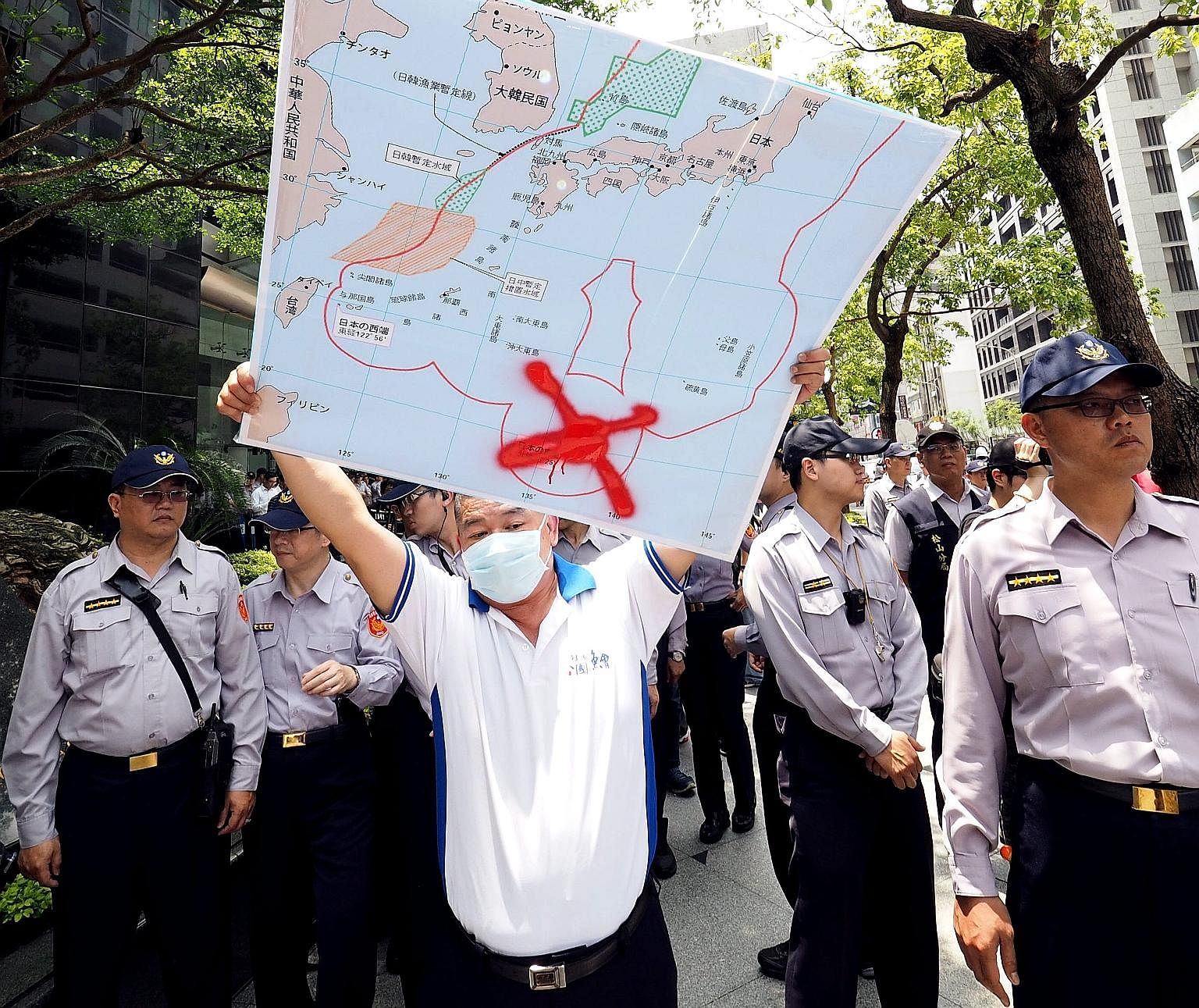 A Taiwanese fisherman with a map showing the location of Okinotorishima Island crossed out, during a protest last month over Japan's seizure of a Taiwanese trawler there.