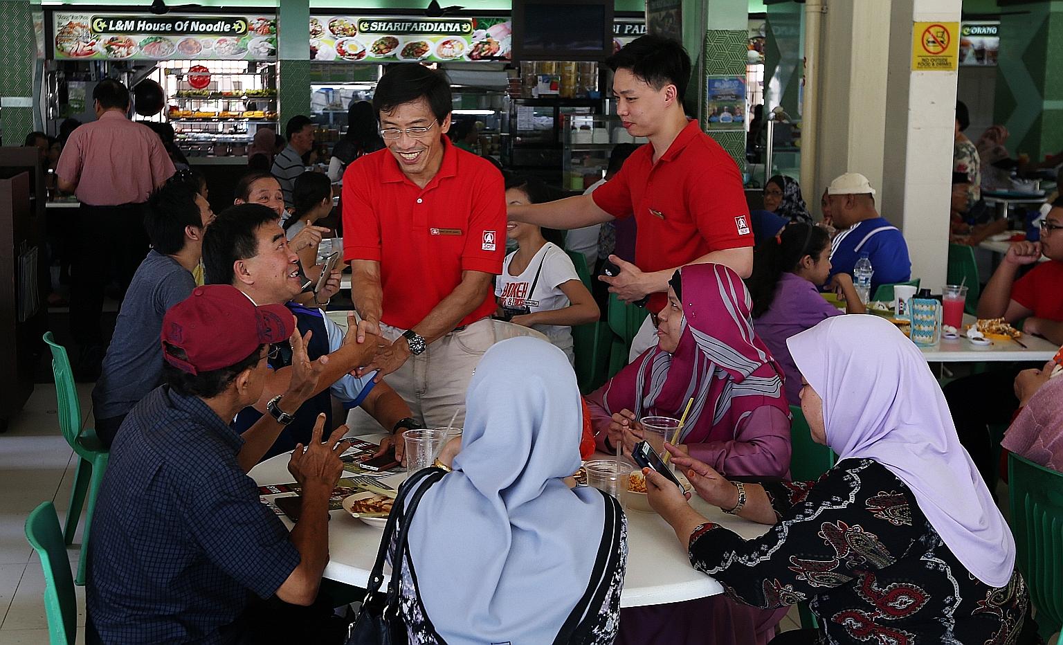 Dr Chee greeting people in Bukit Batok during a walkabout yesterday. Speaking to reporters after an event in the constituency, he reiterated his view that it is impossible for an MP to hold a full-time job and still discharge his responsibilities ful