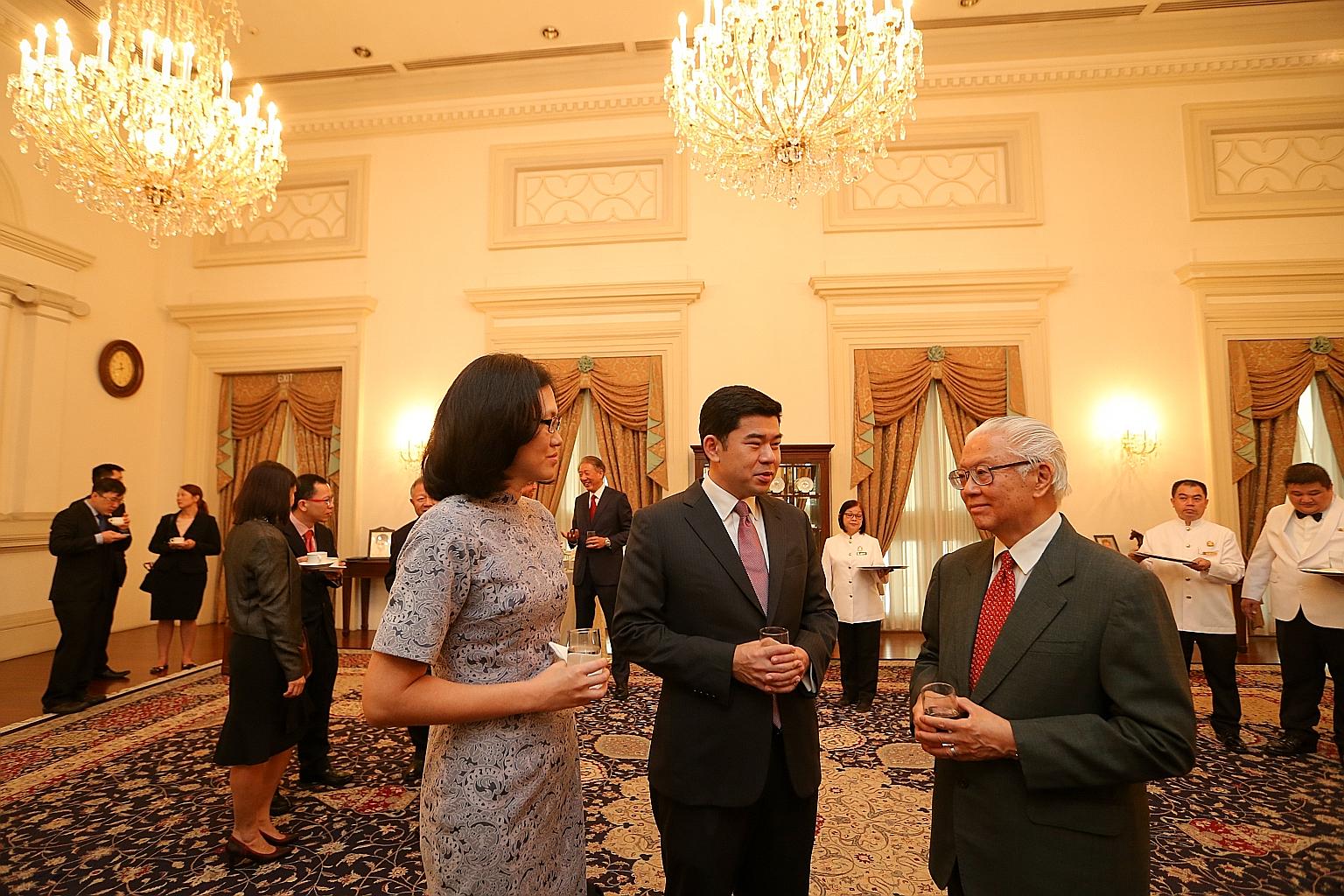 Mr Gabriel Lim, 40, and his wife, Sharon, chatting with President Tony Tan Keng Yam during a reception after Mr Lim was sworn in as Second Permanent Secretary (Ministry of Communications and Information) at the Istana yesterday. Mr Lim, a former prin