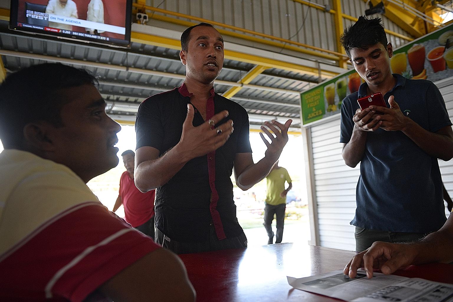 Bangladeshi construction worker Yousuf (centre) with his countrymen yesterday in Tuas View Dormitory. The Home Affairs Ministry says efforts to reach out to and engage the foreign worker population here are ongoing.