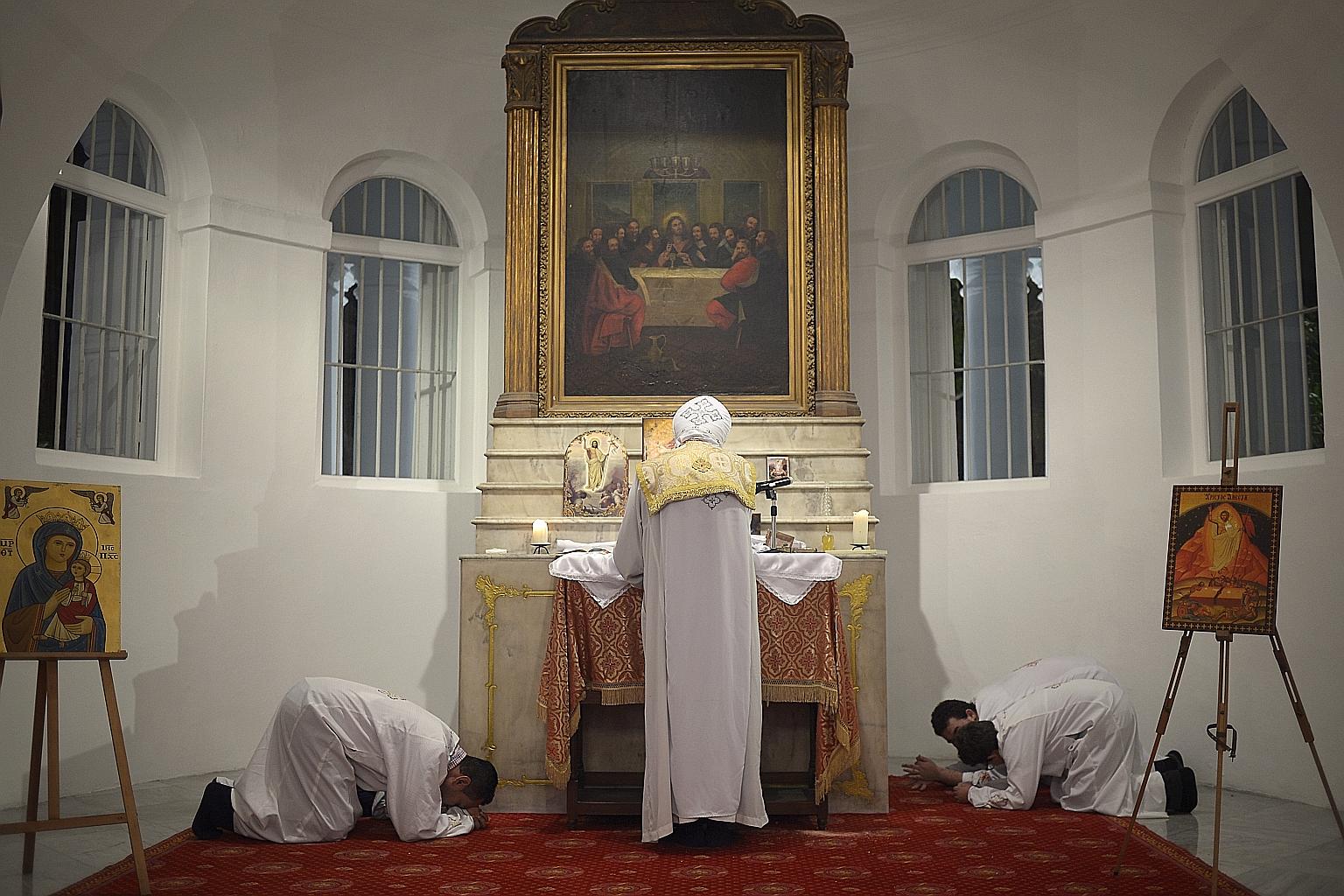 Father Jonathan Ishak flew in from Australia to lead the Singapore Coptic community in prayer during their Easter service at the Armenian Church.