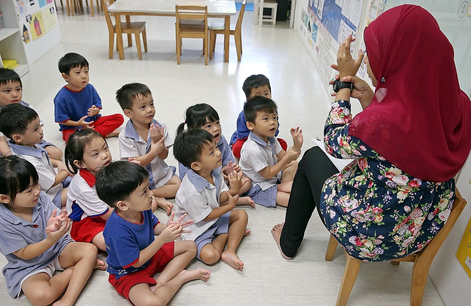 A pre-school teacher with her Nursery 2 class at PCF Sparkletots Preschool@ Fengshan. The Early Childhood Development Agency has launched a programme to help pre-school teachers progress in their careers and take on larger roles. The scheme will put 