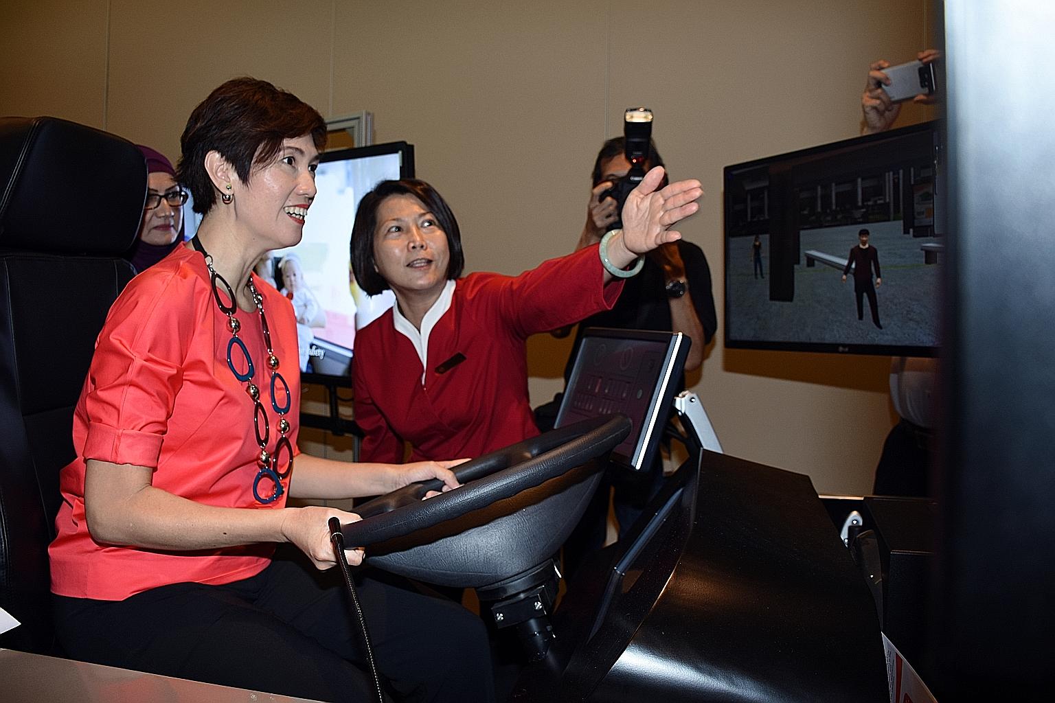 Senior Minister of State for Transport Josephine Teo trying out a bus simulator at the event yesterday. The Government announced plans to ramp up the pool and quality of bus captains under an extensive manpower plan.