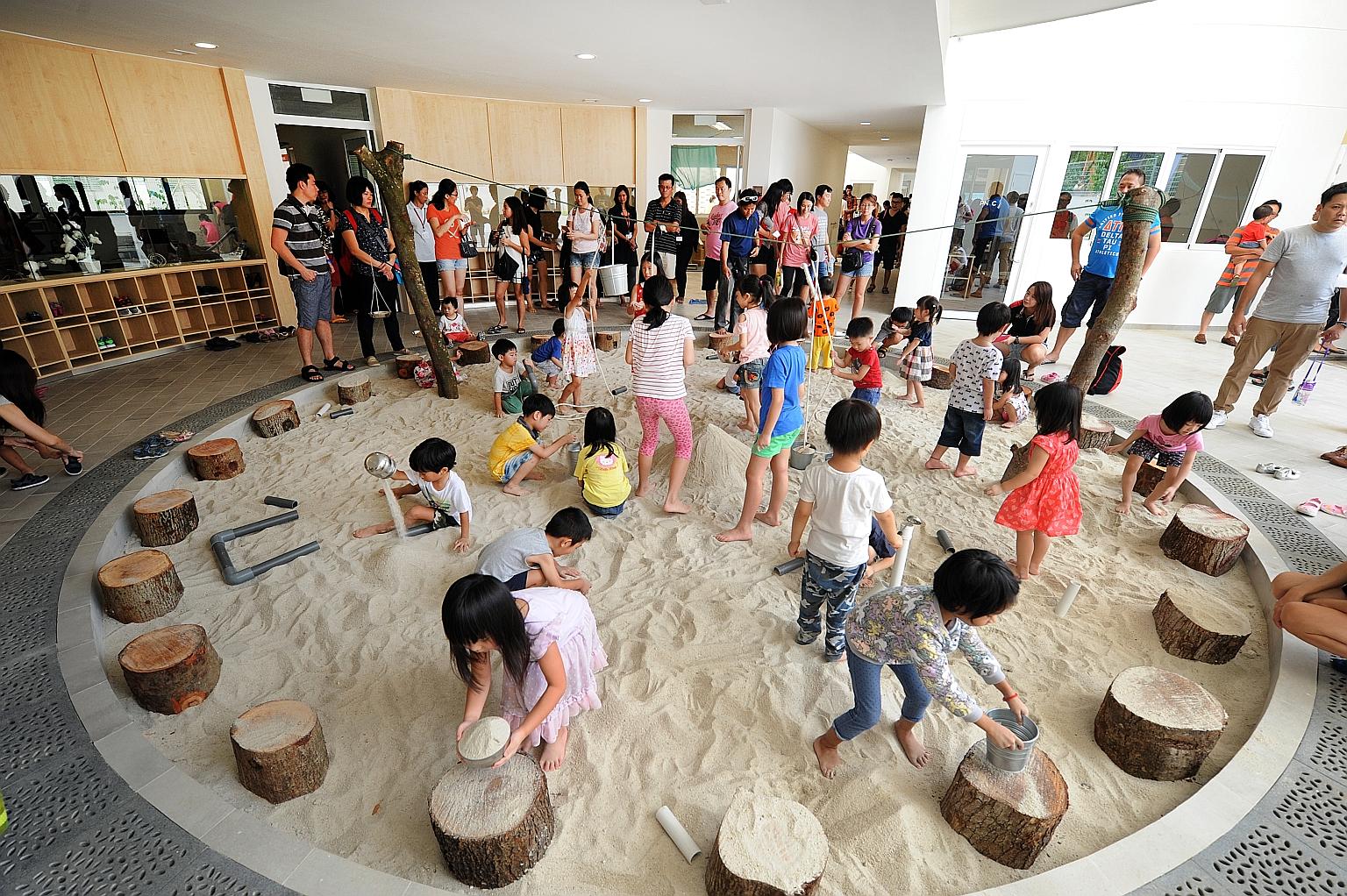Children playing in one of the centre's five "pods", featuring a sand pit which represents "earth", during the official opening yesterday.