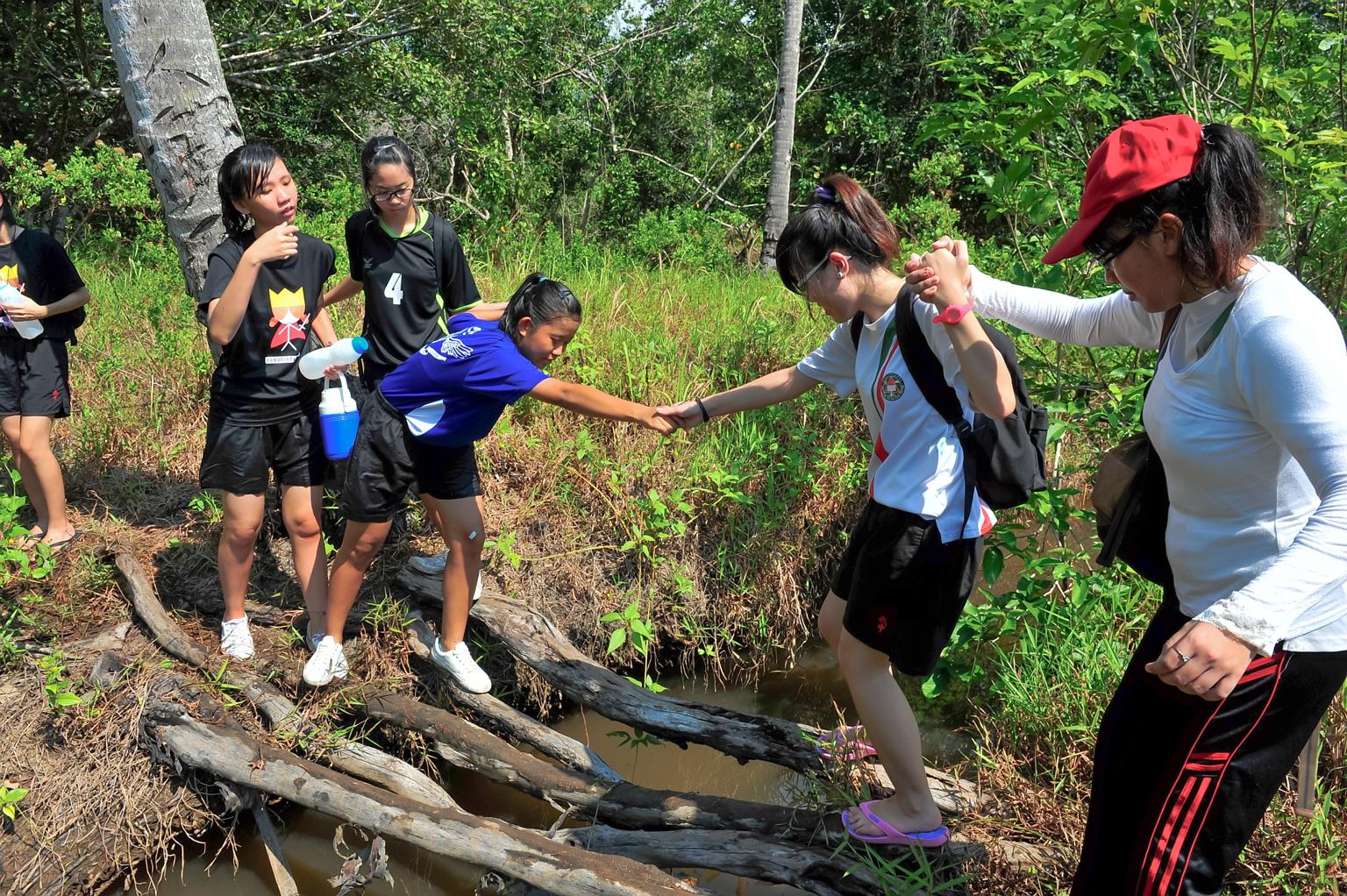 Students from Bukit Panjang Government High School on a nature walk near LooLa Adventure Resort in Bintan in 2011. Outdoor education providers have seen a fall in overseas bookings since last year. They believe this is due to safety concerns and red