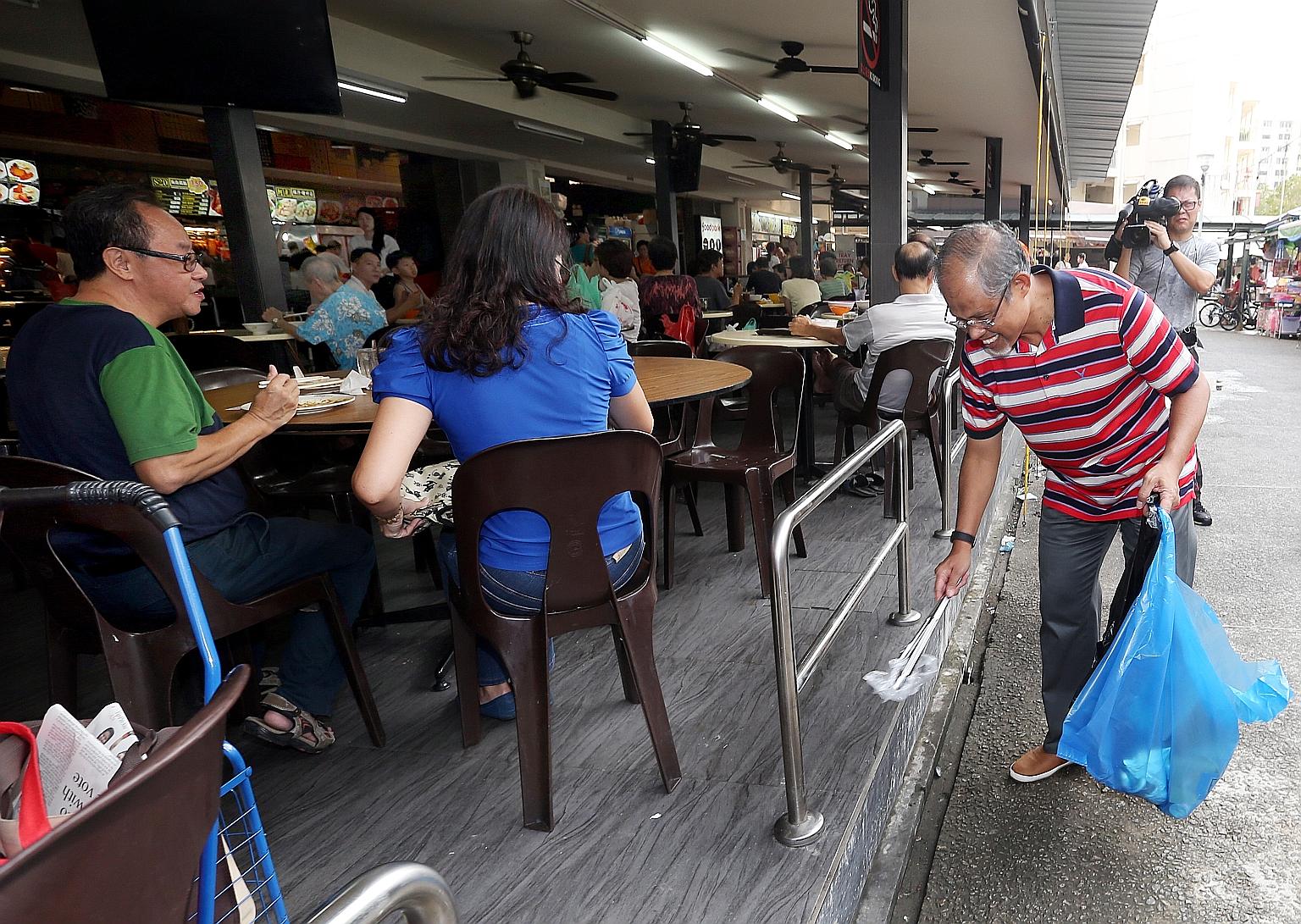 Minister for the Environment and Water Resources Masagos Zulkifli doing his part to keep Singapore clean in Tampines yesterday, as part of the islandwide Operation We Clean Up event. He was among ministers and MPs who were out in force to pick up lit