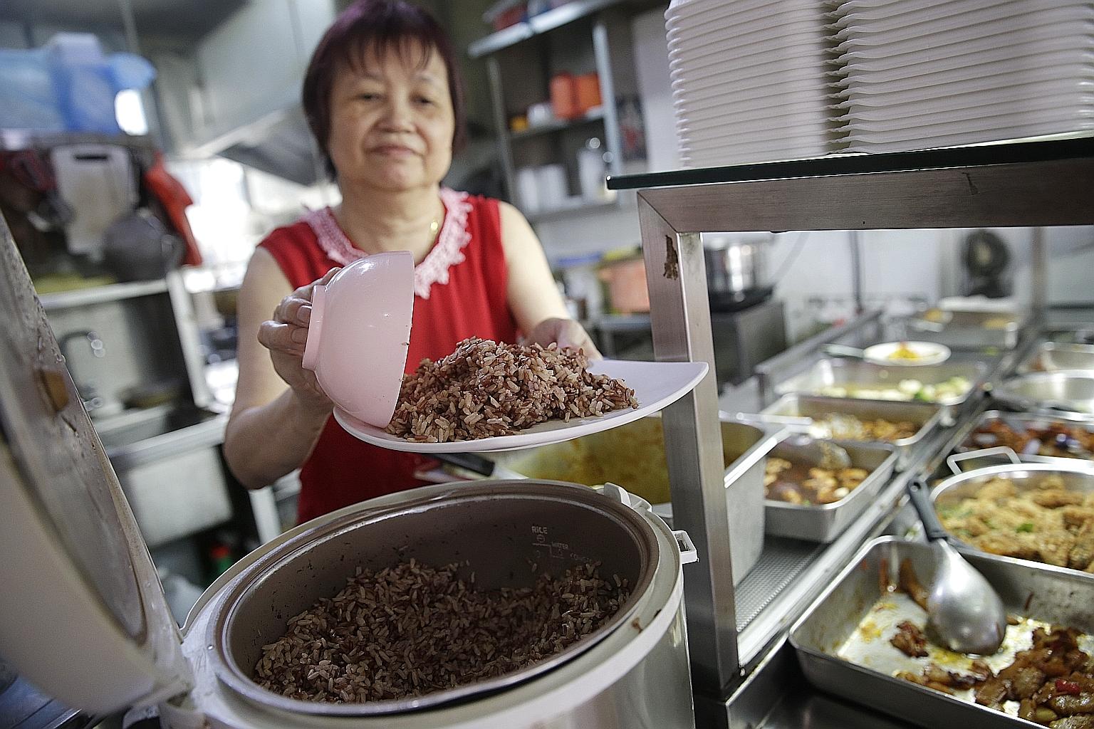Madam Ding serving up brown rice at Fo Lai Ping (Popular) Vegetarian stall. She says five in 20 customers opt for brown rice over white.