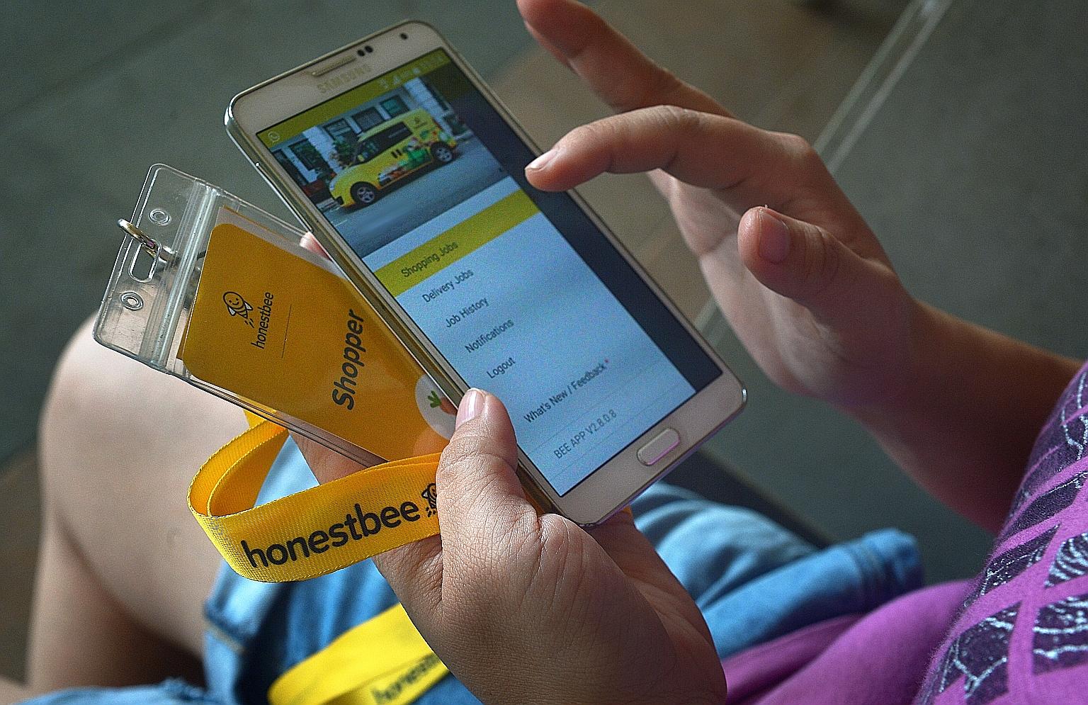 An honestbee shopper checking an app through which shoppers receive orders they have to fill at supermarkets. The firm's CEO and co-founder Joel Sng said shoppers' pay fluctuates based on customer demand.