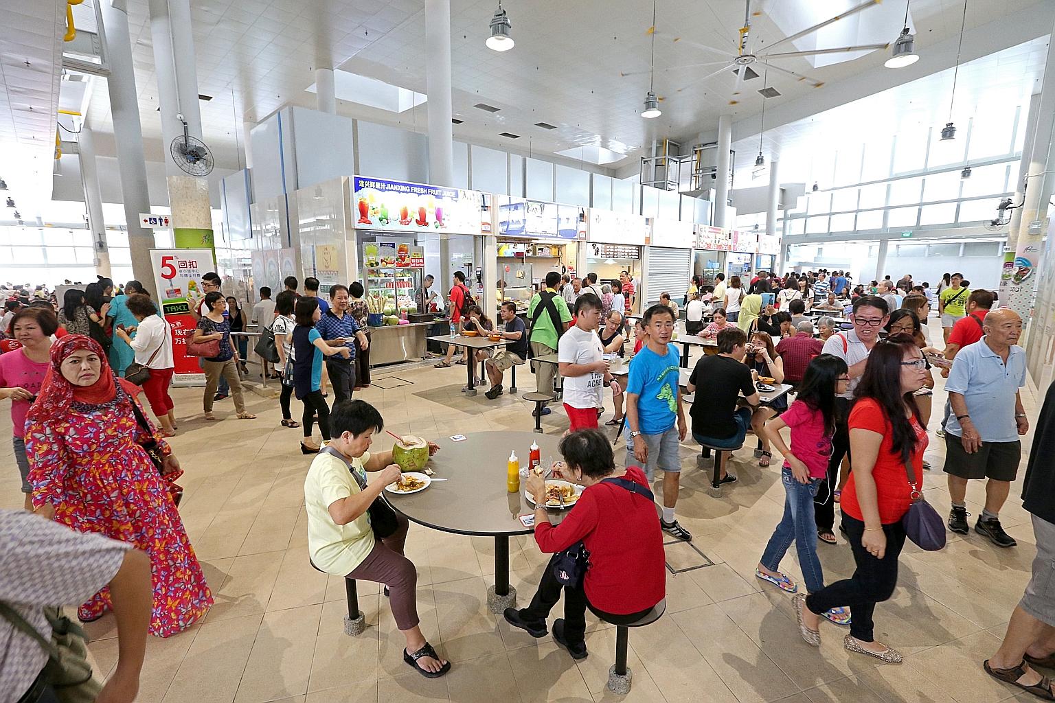 Diners at the Bedok Interchange hawker centre. Senior Minister of State for the Environment and Water Resources Amy Khor yesterday said that the Government will encourage hawkers, as much as possible, not to use disposable ware, particularly for dini