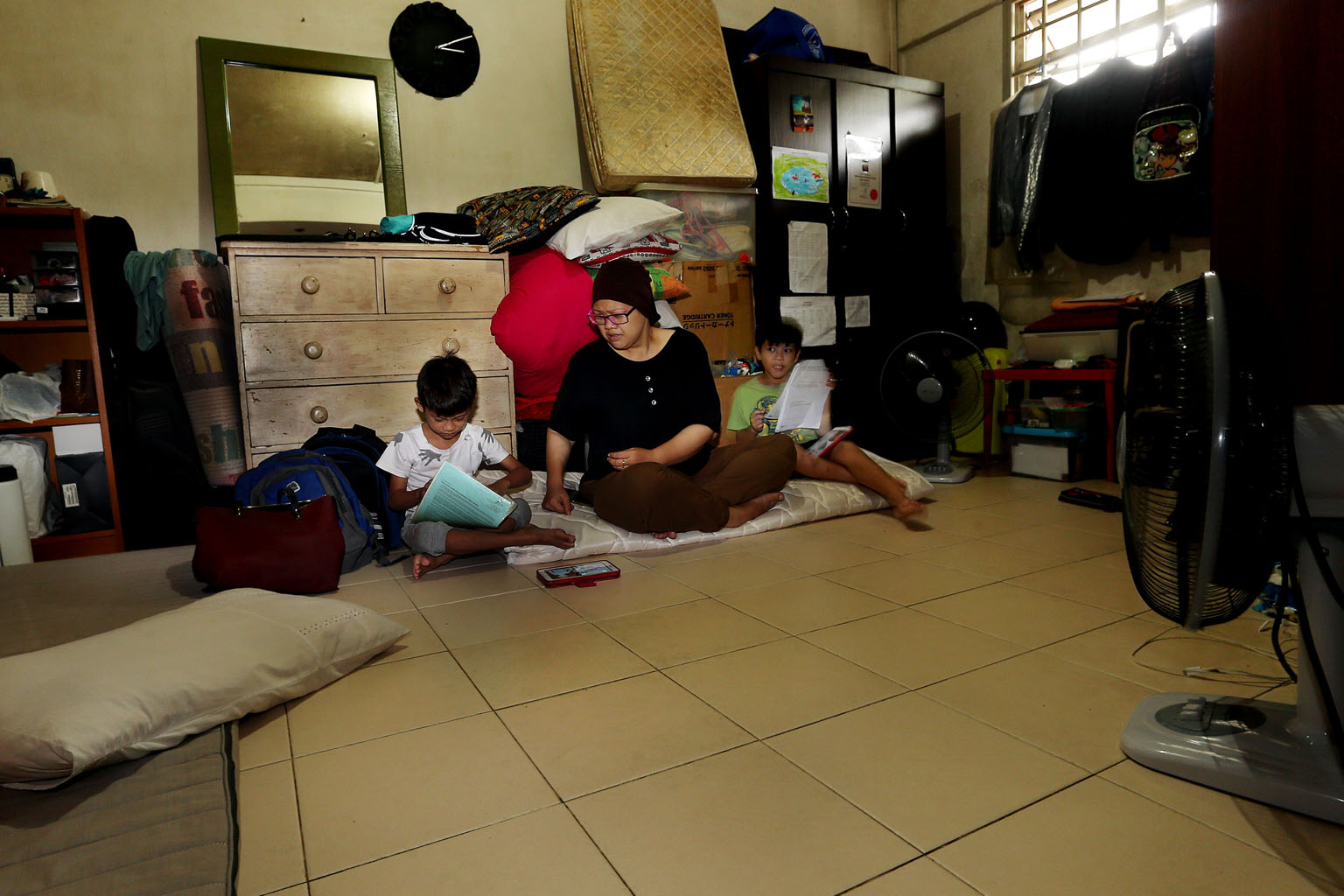 Ms Renemarlina and her two children went from living in a three-room flat to staying in her parents' rental flat after she got divorced. She is currently looking for a job and intends to buy a Housing Board flat once she can afford one.
