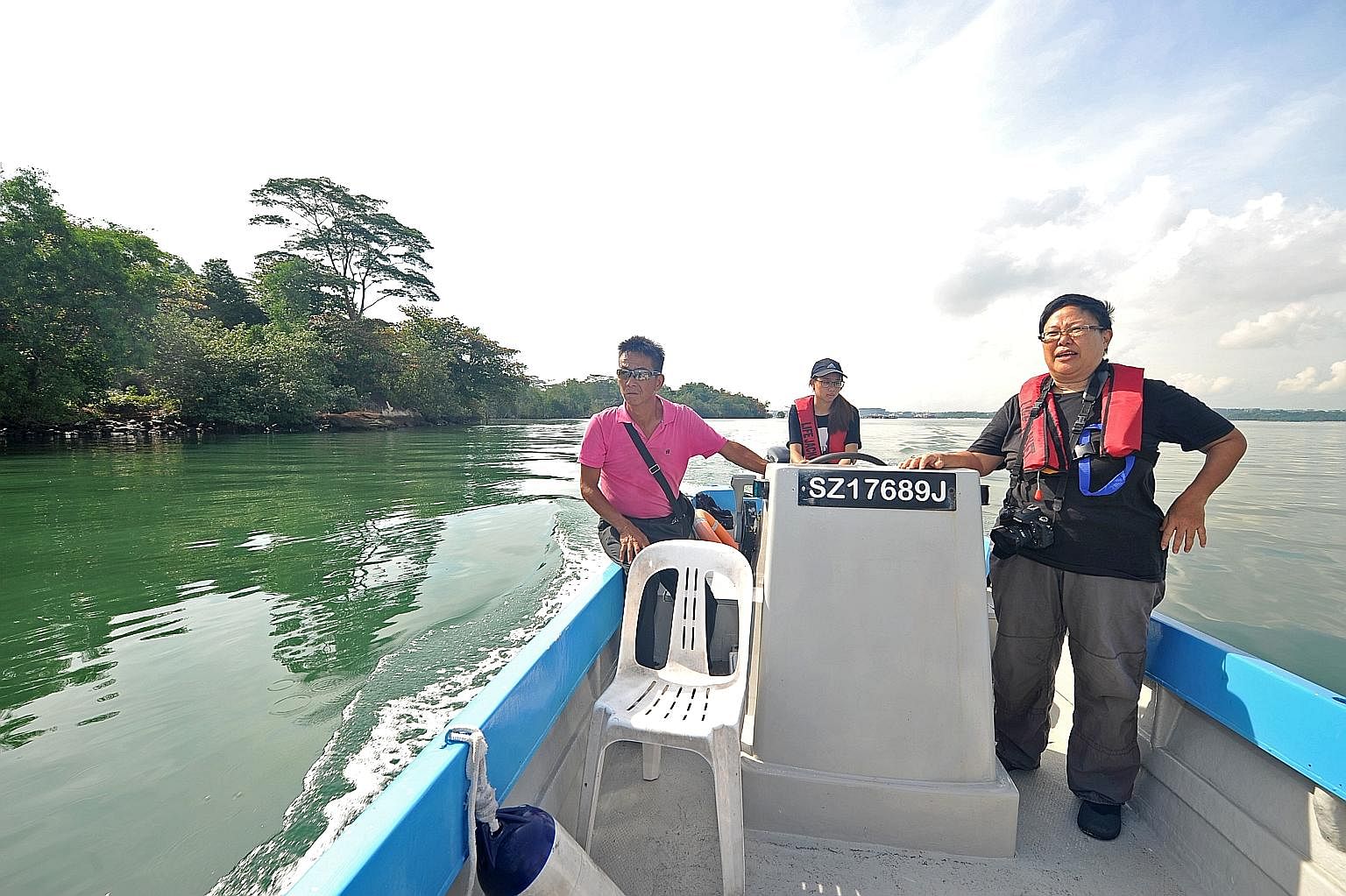 (From left) Ubin fish farmer Philip Lim, geography student Vanessa Teo and Pesta Ubin coordinator Ria Tan on a boat tour through Ubin's mangroves. Go kayaking at Ubin Quarry (above) with Outward Bound Singapore instructors. Explore Ubin town.