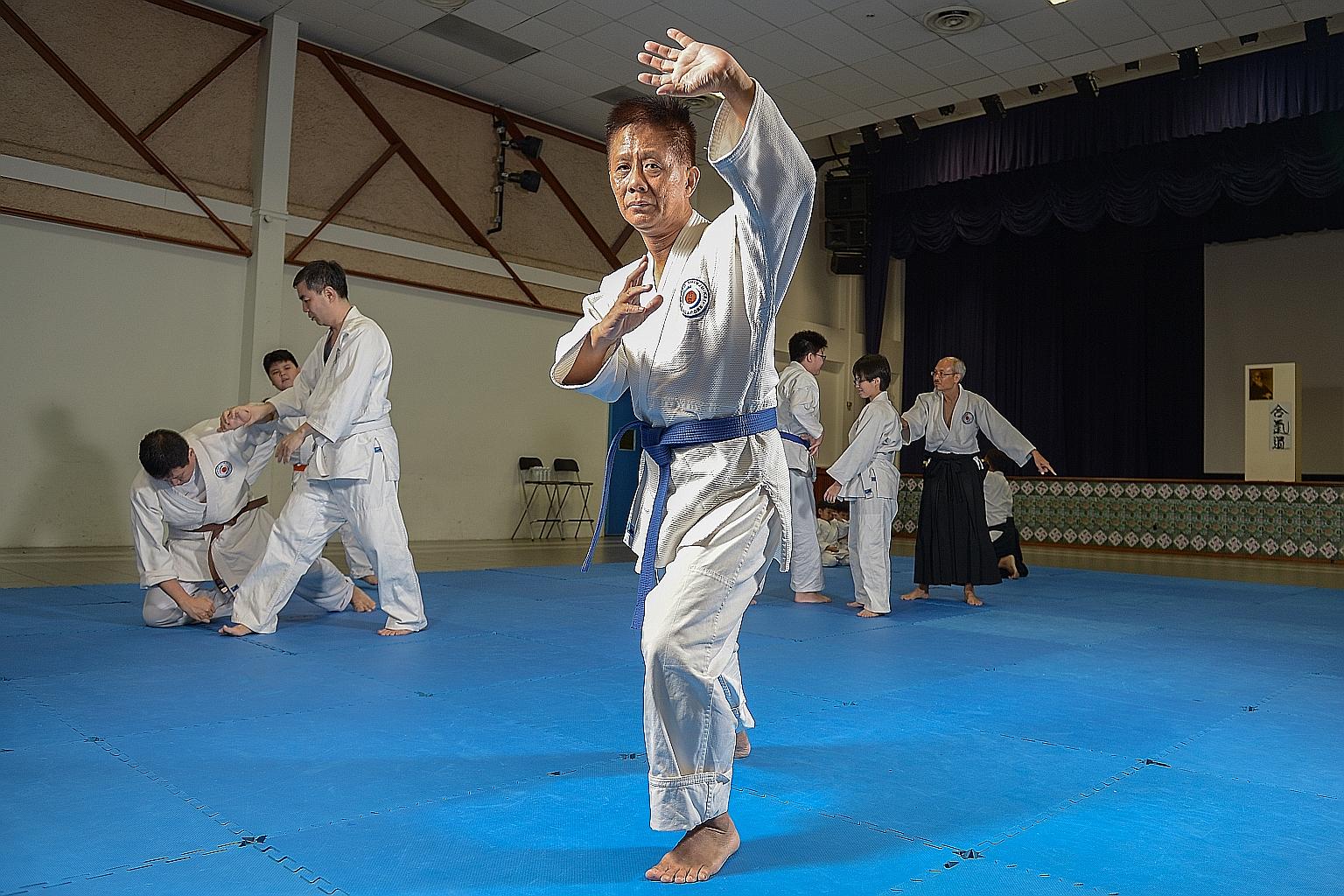 Mr Lim (centre) goes for martial arts classes in wing chun and aikido every week, and has a blue belt in aikido. The freelance financial adviser enjoys picking up new skills, and graduated with a specialist diploma in business analytics from Republic