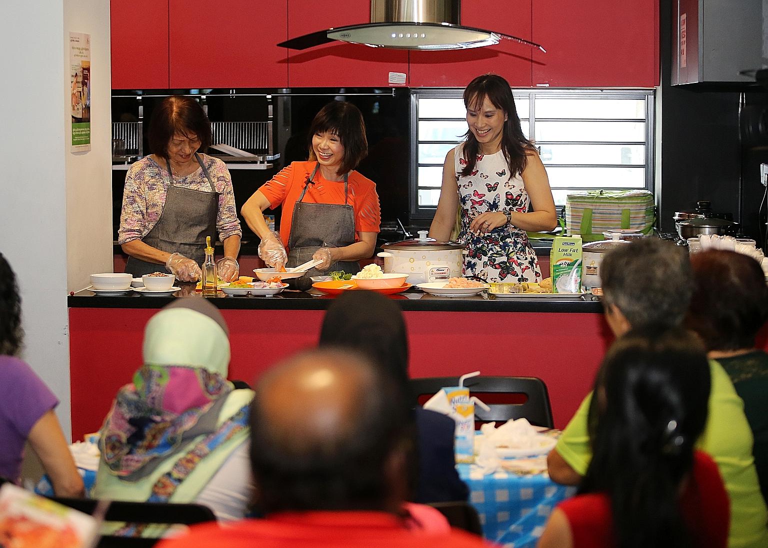 Dr Khor (centre) giving a cooking demonstration of two dishes featured in the recipe book - sweet potato oats and chicken and vegetable stew - at the launch event yesterday.
