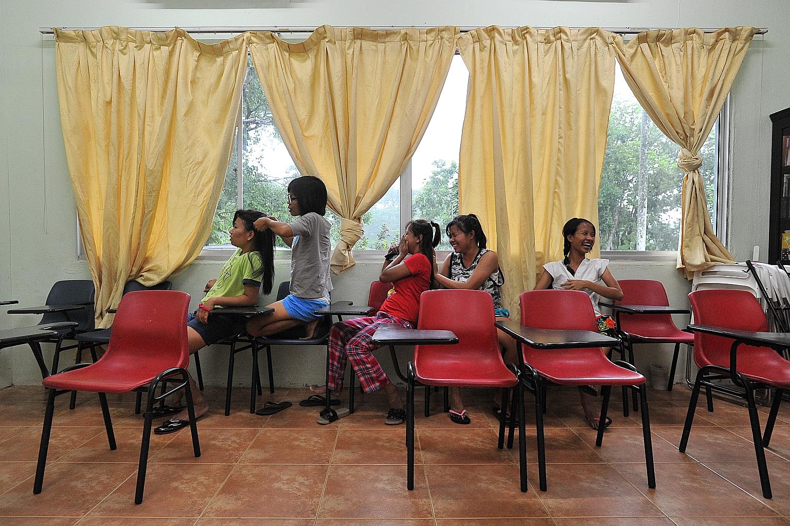 Maids from Myanmar and India enjoying a lighter moment at Well Care Home in Woodlands. The 250-bed facility houses trainee maids, those who are being transferred, and those whose employers are on holiday. Employment agents must inform the Manpower Mi