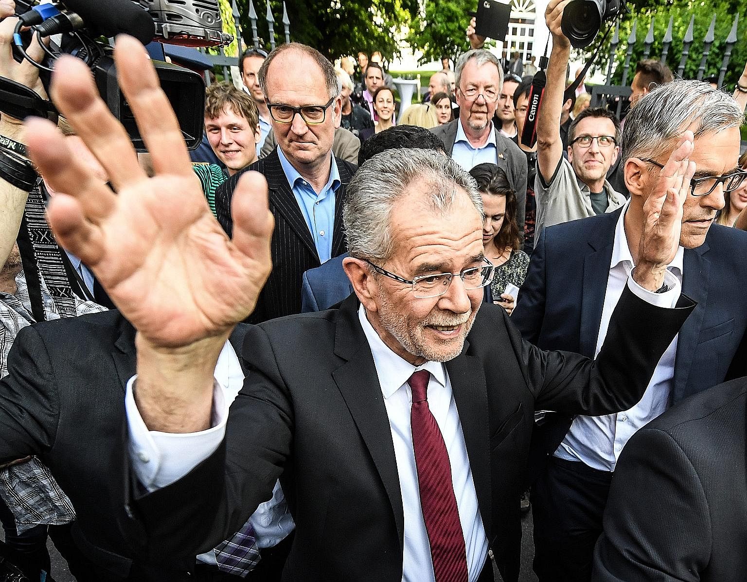 Austrian President-elect Alexander Van der Bellen, who is supported by the Green Party, waving after delivering a statement on Monday, following the presidential election run-off.