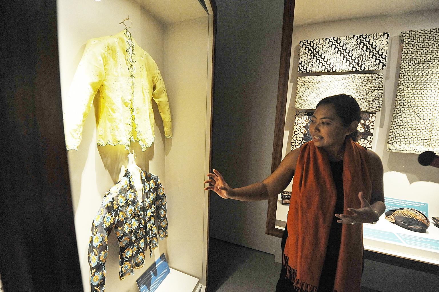 Malay Heritage Centre curator Suhaili Osman with hand-embroided kebaya blouses, which are among the more than 35 items on display.