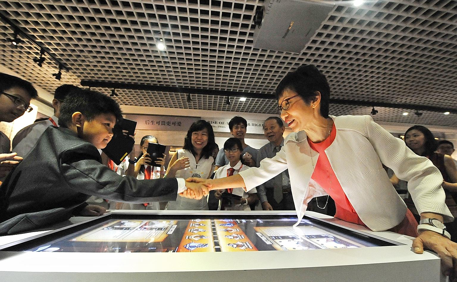 Eight-year-old Trevor Tan shaking hands with Minister for Culture, Community and Youth Grace Fu after she beat him in a multimedia game. Trevor is the great-great-great-grandson of Teo Eng Hock, who was one of the founding members of the Kuomintang. 