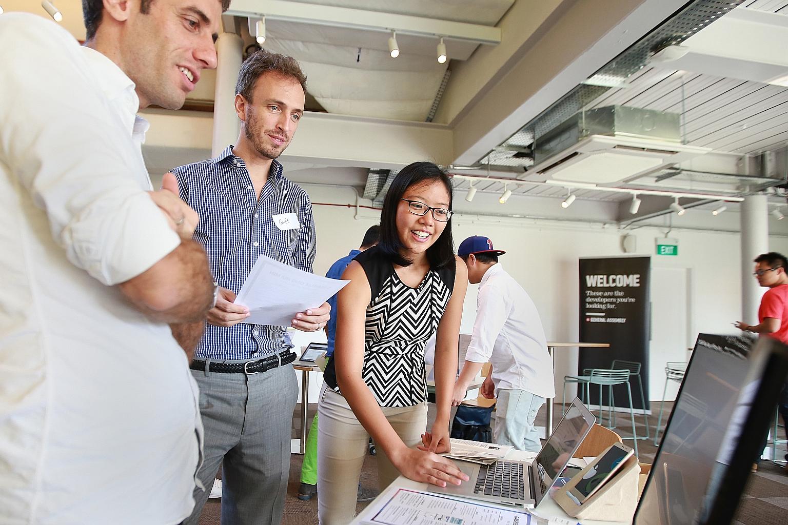 Ms Ong showing potential employers tech projects that she worked on. She attended a crash course on Web development at General Assembly Singapore after her A levels, and is now considering two offers to become a junior developer for tech companies.