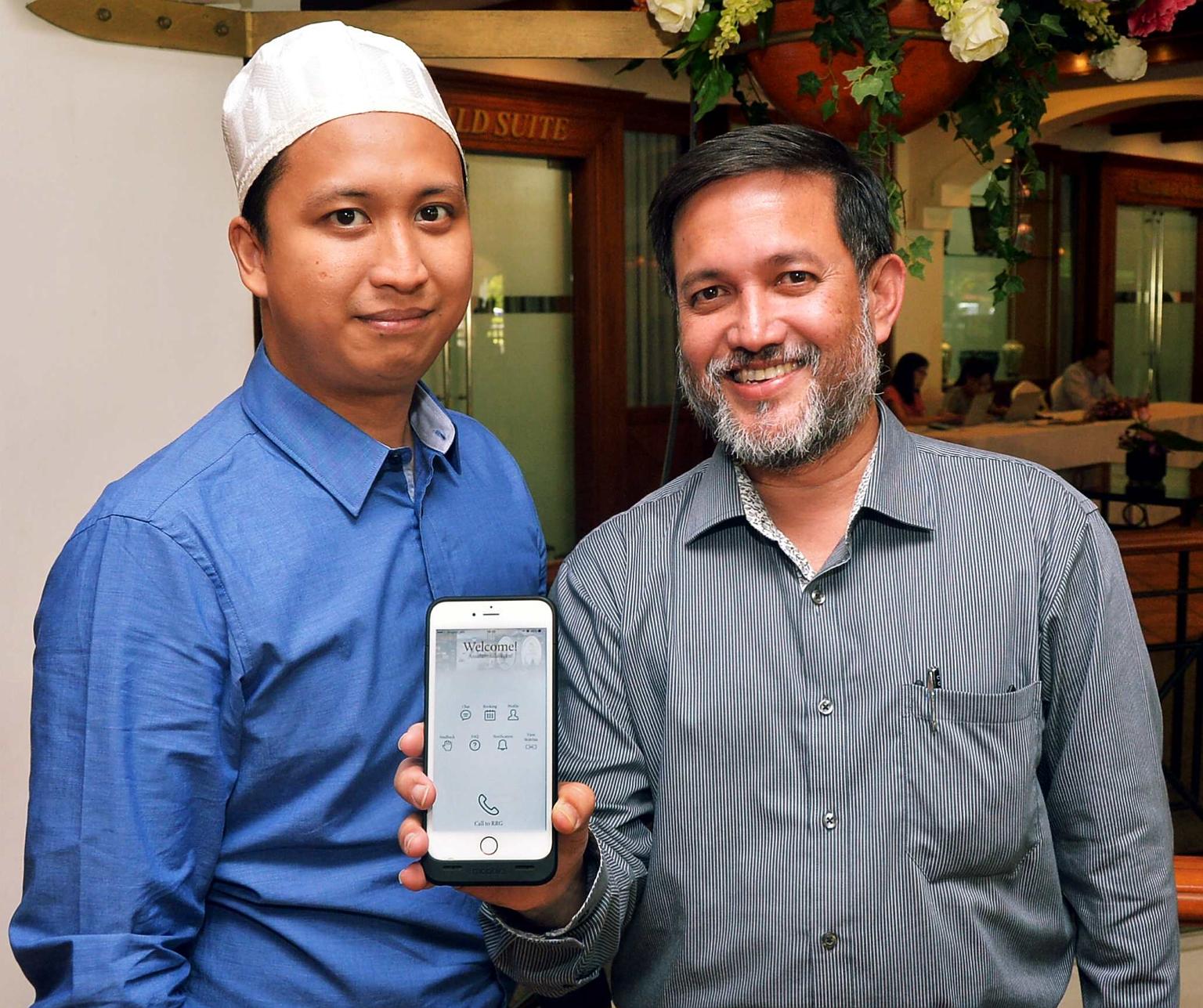 Showing off the new app are Mr Salim Mohamed Nasir (right), head of the Religious Rehabilitation Group (RRG) secretariat, and Mr Ahmad Saiful Rijal Hassan, a counsellor and RRG secretariat member.