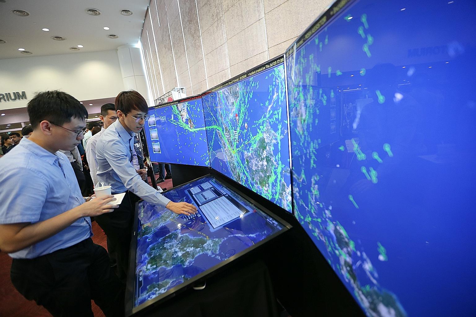 Defence Science and Technology Agency engineer Lok Xin Quan demonstrating the National Maritime Security System at the Public Service Engineering Conference yesterday.