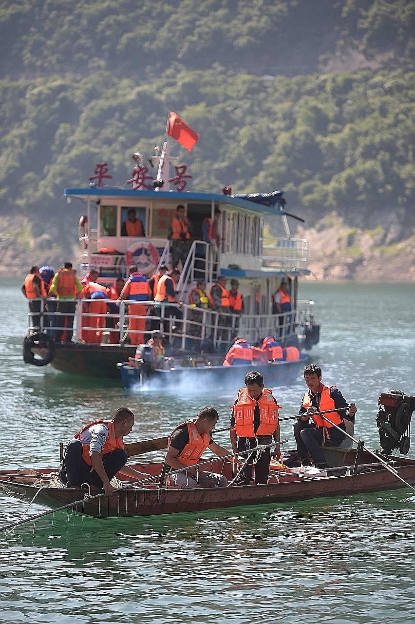 Chinese search- and-rescue workers using magnetic positioning devices and underwater cameras to search for survivors after the leisure boat Shuanglong capsized in Bailong Lake amid strong winds on Saturday.