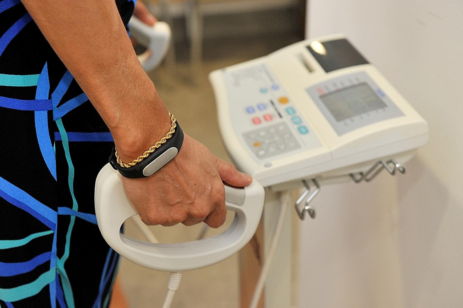 A volunteer on a body composition analyser, used to measure body weight and body fat distribution. Health Ministry figures show that more than one in four people here are diabetic, or are heading that way.