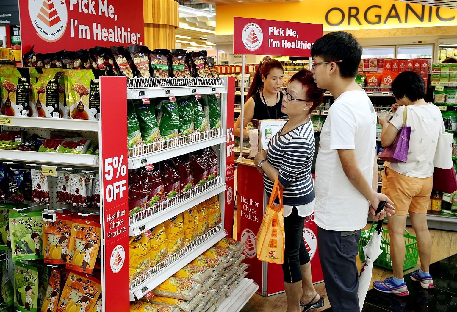 Supermarkets, including FairPrice Xtra at JEM shopping mall (above), are promoting wholegrain rice items as the Health Promotion Board says white rice is its main concern in fighting diabetes.