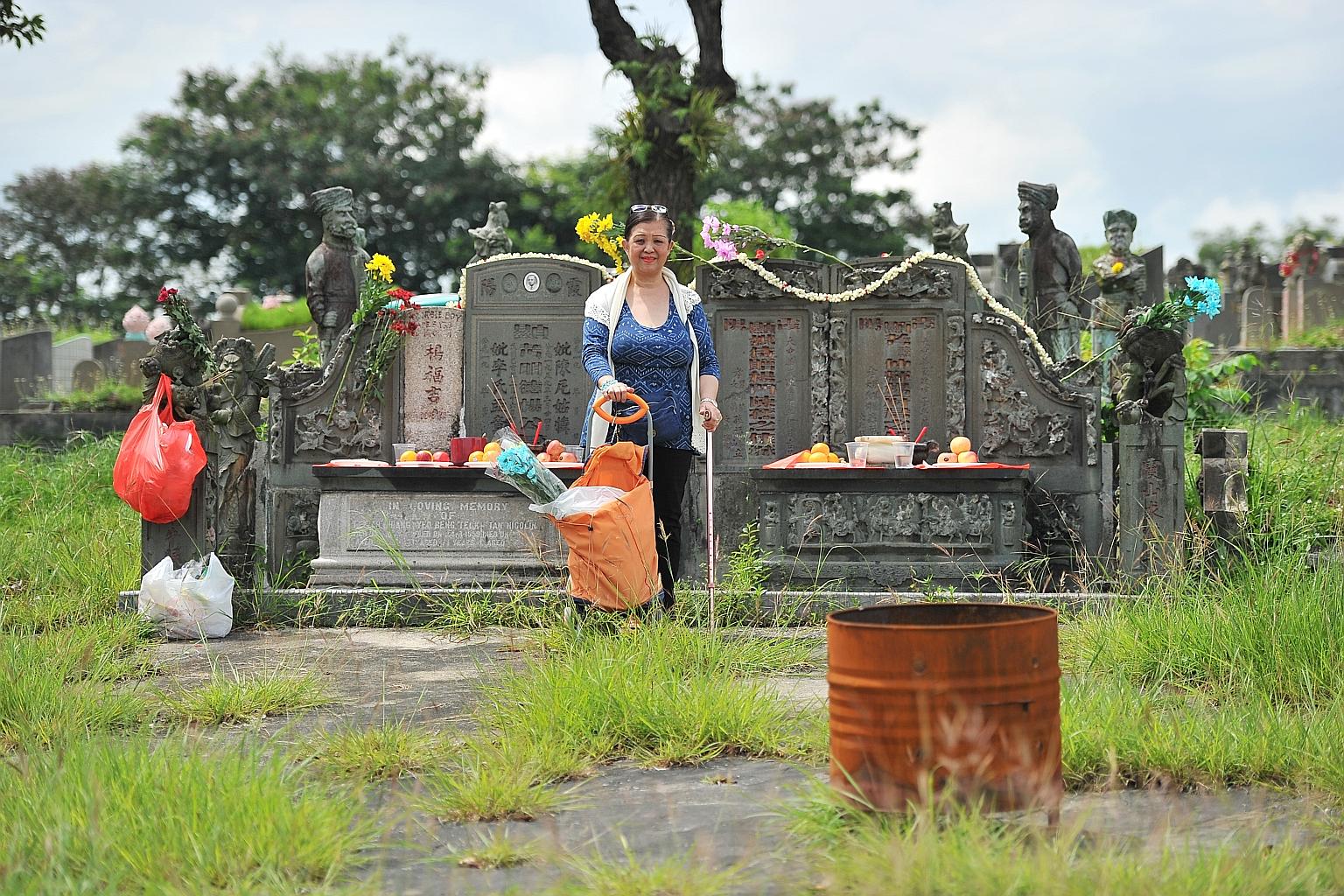Ms Yeo beside the mass grave of four of her ancestors, which is flanked by statues of Sikh guards and Chinese military warriors, at Choa Chu Kang Cemetery. The wealthy Yeo family moved here from China and Semarang in Indonesia in the late 1800s.