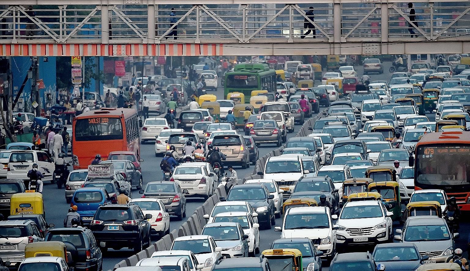 Nations like India, whose cities are beset by slums, yearn for a prosperous urban future. But getting there will require major governance and policy changes. This is because their cities, such as India's New Delhi (above), are places where traffic cr