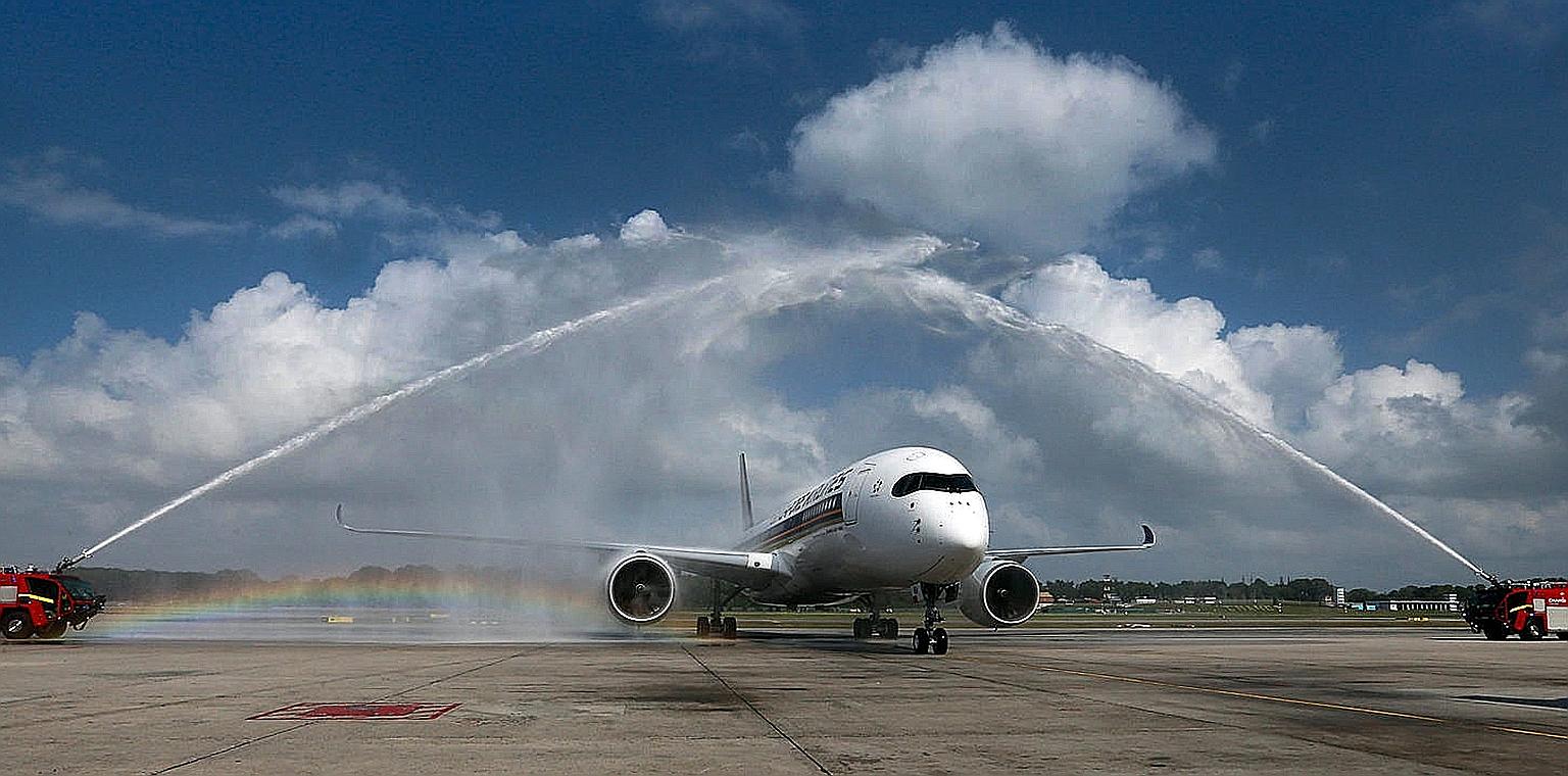 Two fire engines giving the first of 67 Airbus 350s a water-cannon salute on its arrival at Changi Airport's Terminal 3 on March 3. The new SIA flights to San Francisco will use A350-900 aircraft.