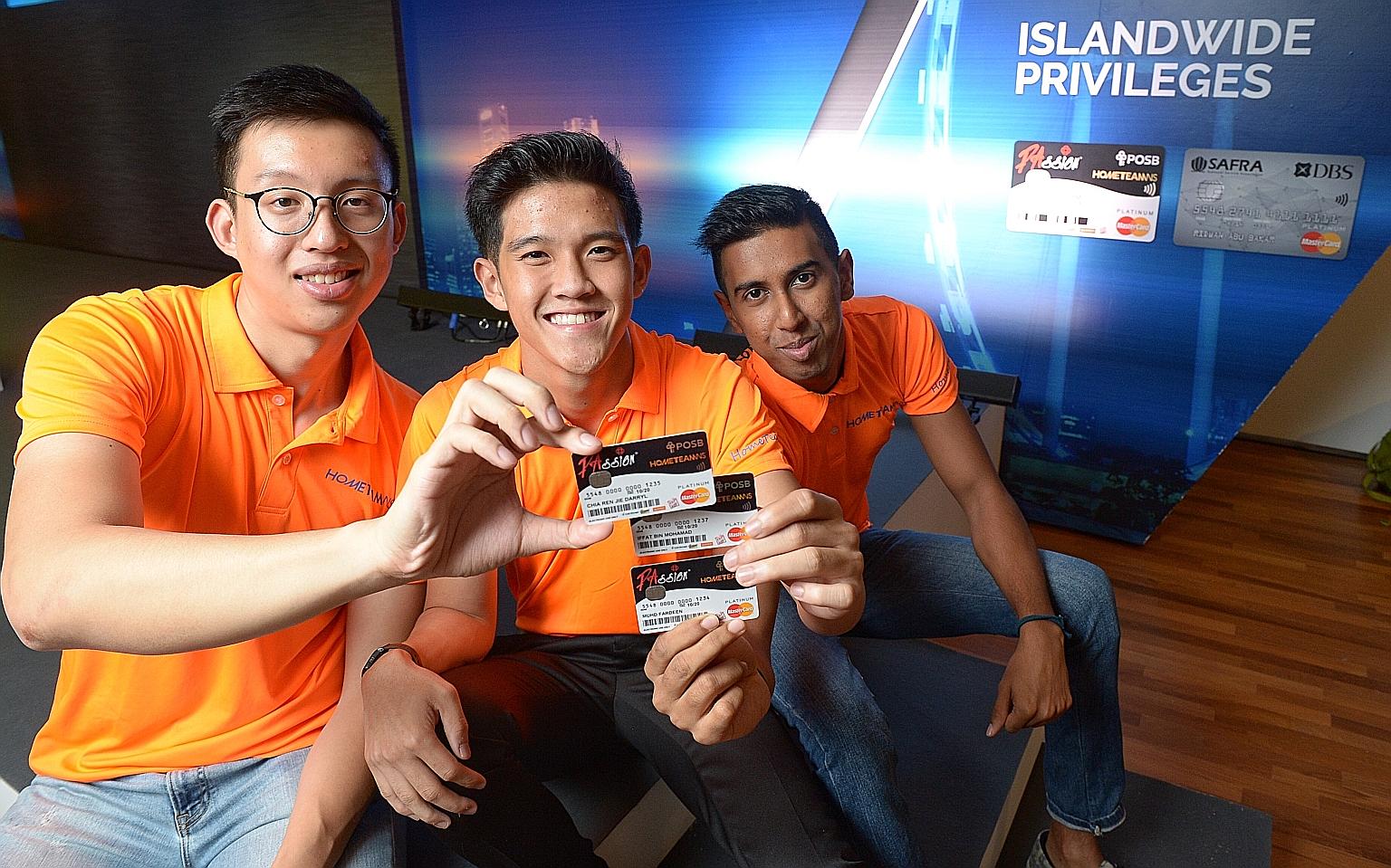 From left: Lance Cpl Chia; Sergeant Iffat Mohamad Rafi, 19, a staff assistant at the Police National Service Department; and Lance Cpl Muhd Fardeen, 23, a firefighter at Sentosa Fire Station, with their newly acquired HomeTeamNS- PAssion-POSB debit c