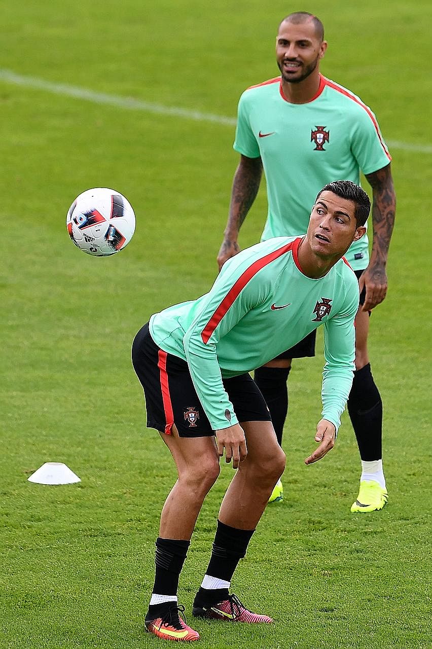 Portugal's Cristiano Ronaldo (front) and Ricardo Quaresma during training at the team's base camp in Marcoussis, south of Paris.