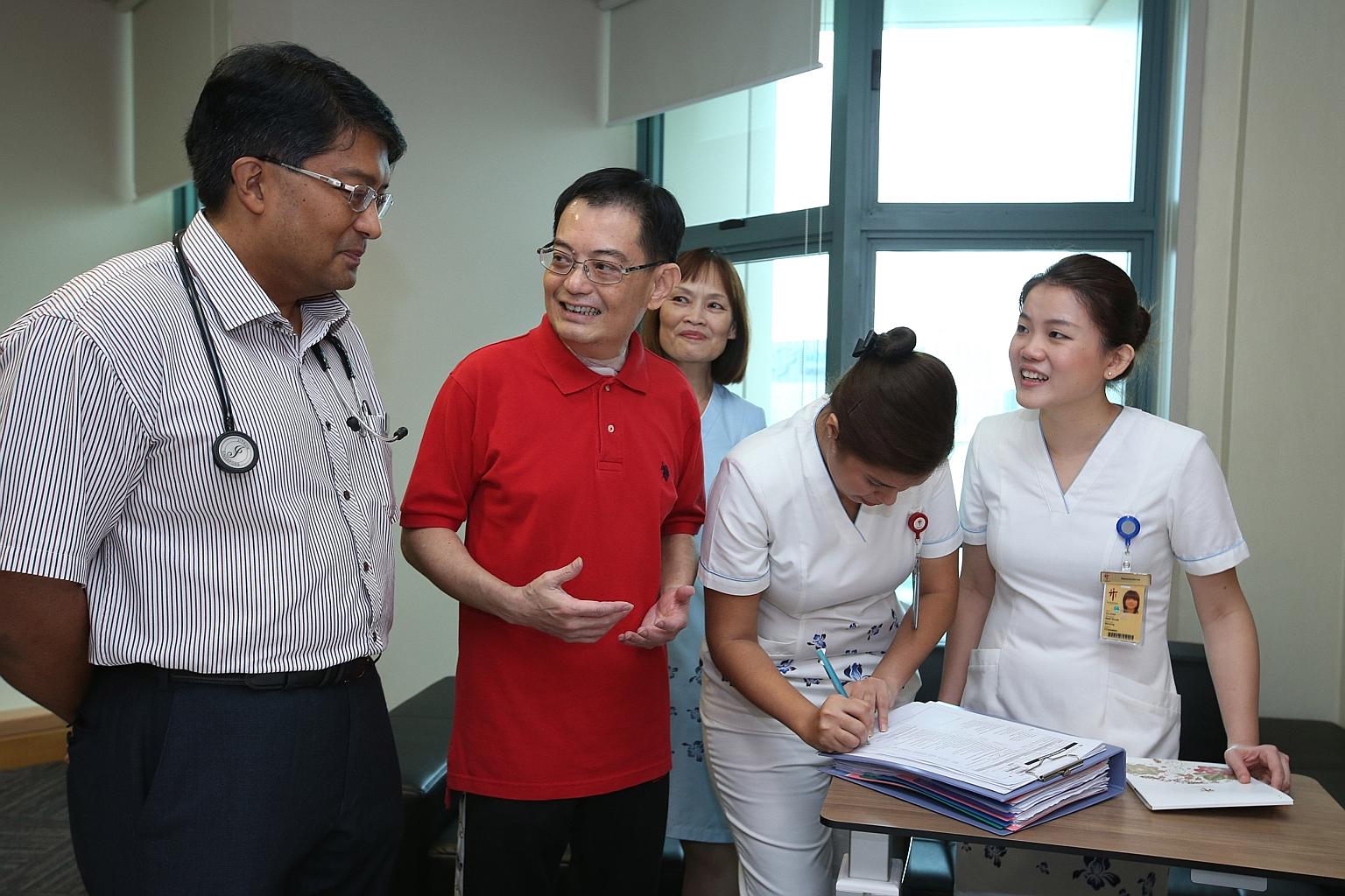Mr Heng with Clinical Associate Professor John Abisheganaden from the Endoscopy Centre, Respiratory and Critical Care Medicine Clinic, and nurses of Tan Tock Seng Hospital yesterday. Six weeks after suffering a stroke, he is fit enough to go home.