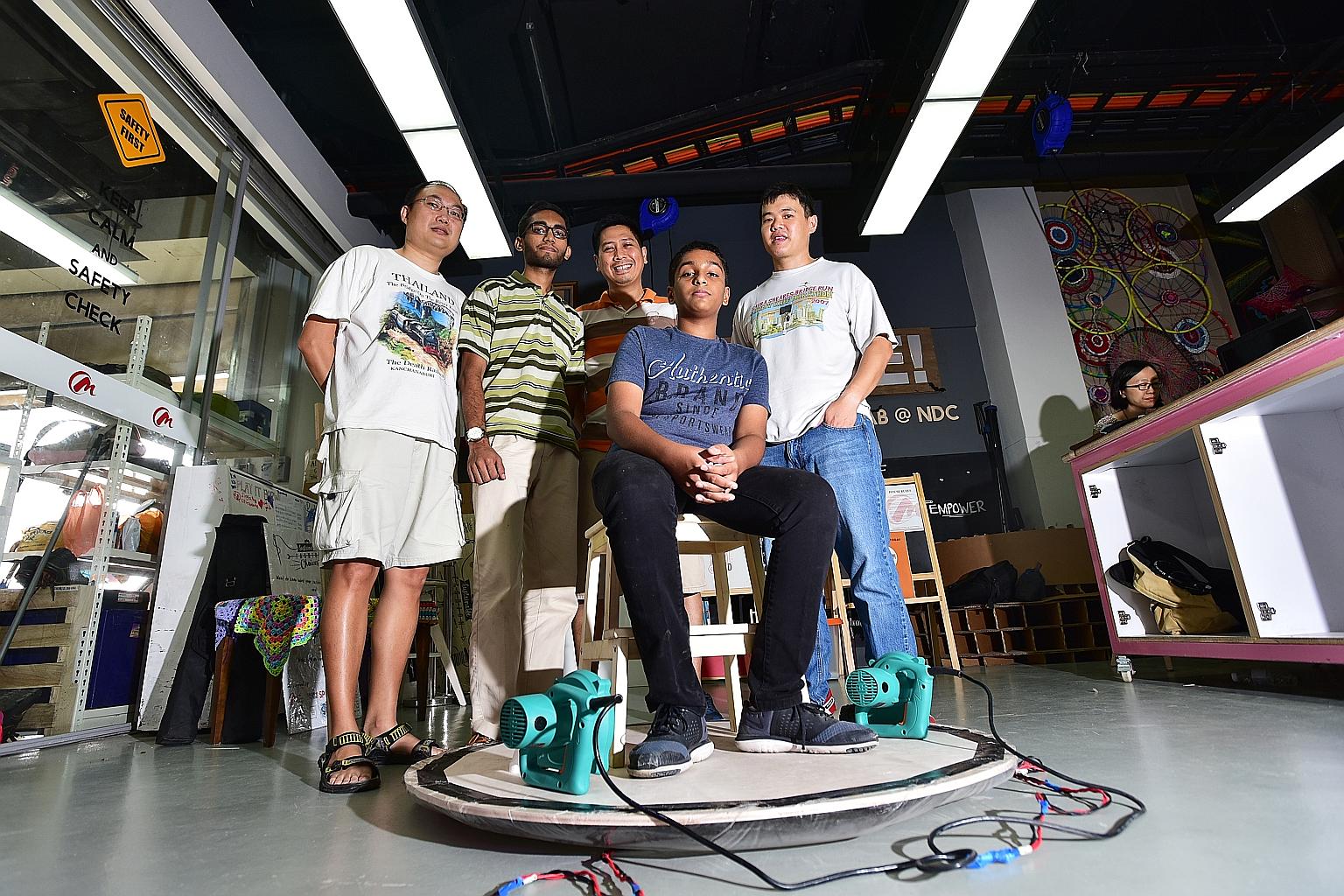 Kartikey atop his hoverboard, with team members (from left) Jeffrey Teo, Vairavan Ramanathan, Jerome Castaneda and Dennis Chu. The craft was created using two leaf blowers and discarded plastics.