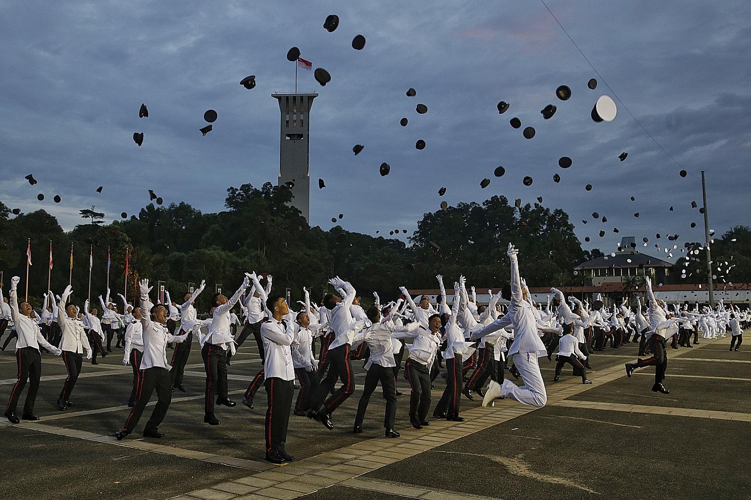 New officers celebrating at the end of yesterday's Officer Cadet Course commissioning parade at Safti Military Institute, which celebrates its 50th anniversary this year. At the parade, PM Lee paid tribute to the pioneer batch, saying that he hoped t