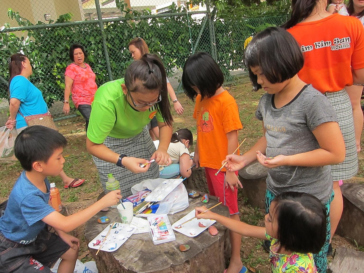 Woodlands residents learning how to grow their own vegetables, make herbal tea, paint on pebbles and create eco-craft items at an event organised by students of Evergreen Secondary School on March 12.