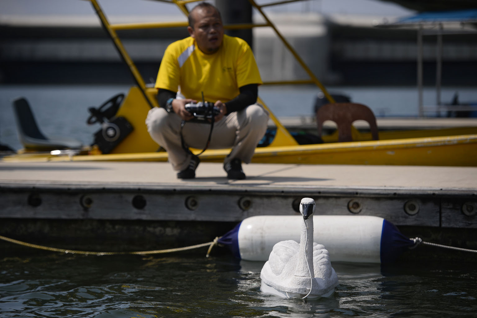PUB assistant engineer Ramli Tahir operating a robotic swan - New Smart Water Assessment Network (NUSwan) - which conducts real-time monitoring of water quality in reservoirs.