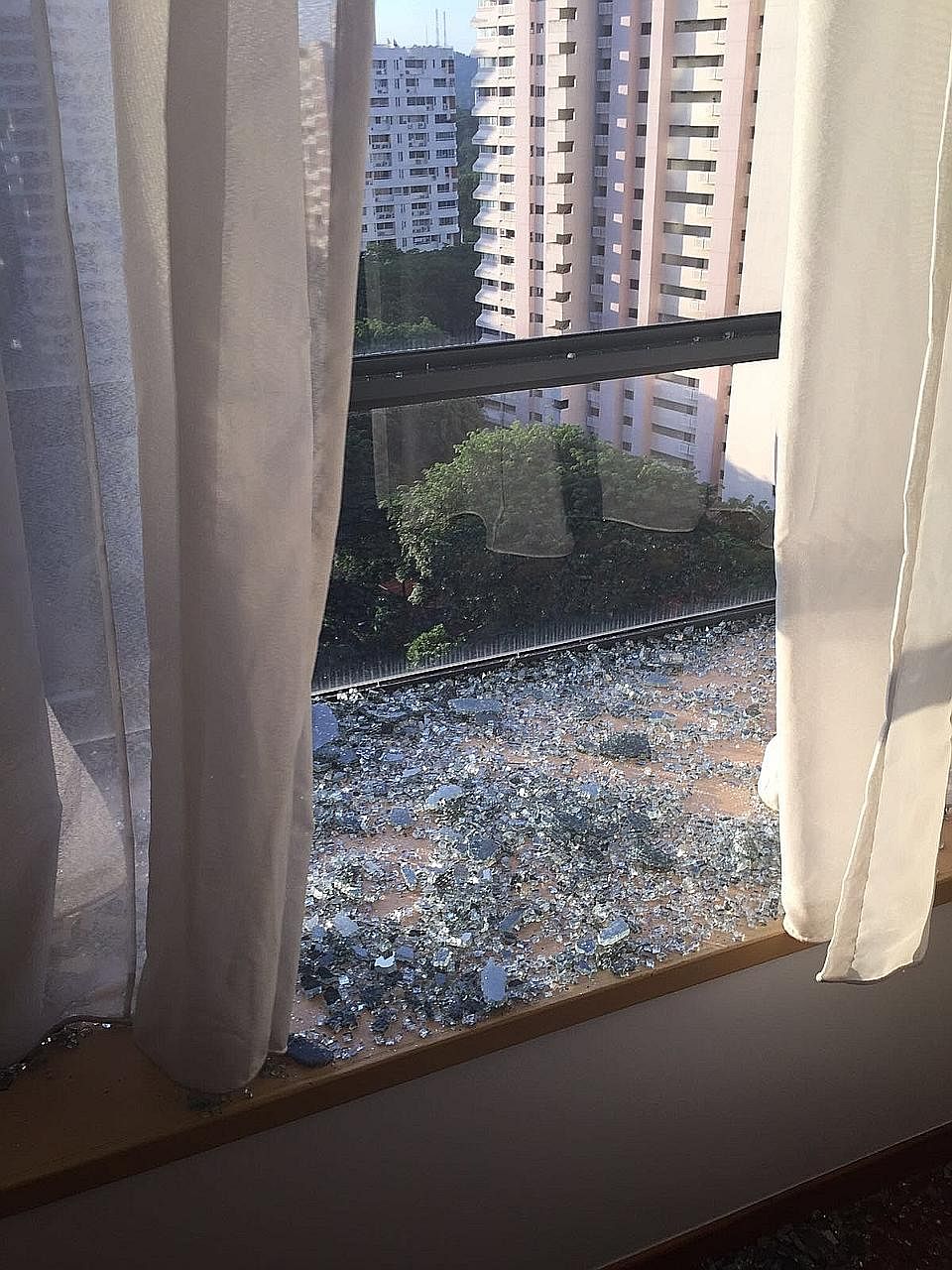 The shattered window at the home of Mr David. Over the past four years, BCA has received an average of 15 reports on glass shattering per year from a total of 25 condos.