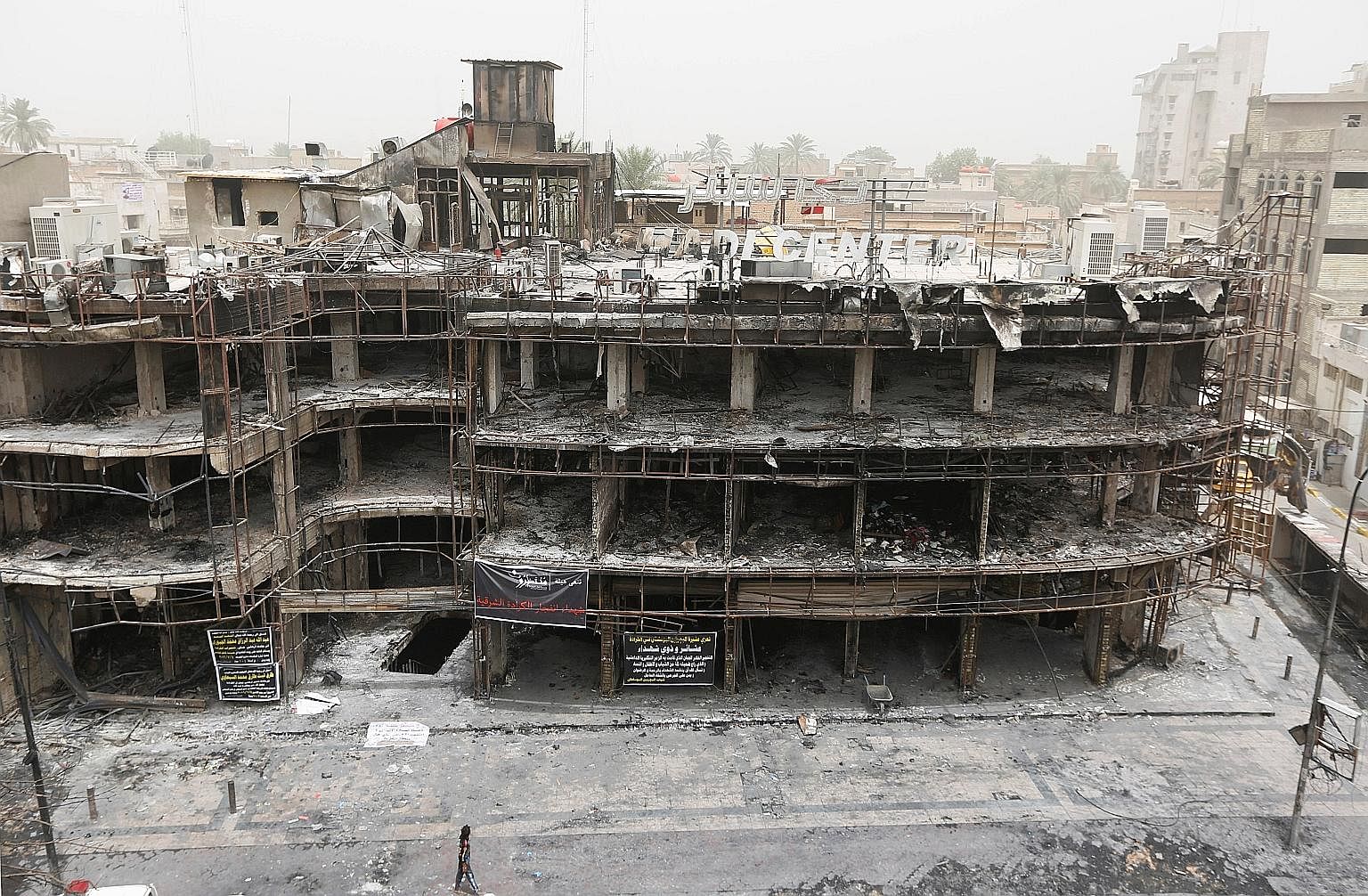 The site of a suicide bomb attack in the shopping area of Karrada in Baghdad on Sunday which killed at least 213 people, one of three major attacks linked to ISIS in the past week. It follows a deadly cafe siege last Friday in Dhaka in which 20 hosta
