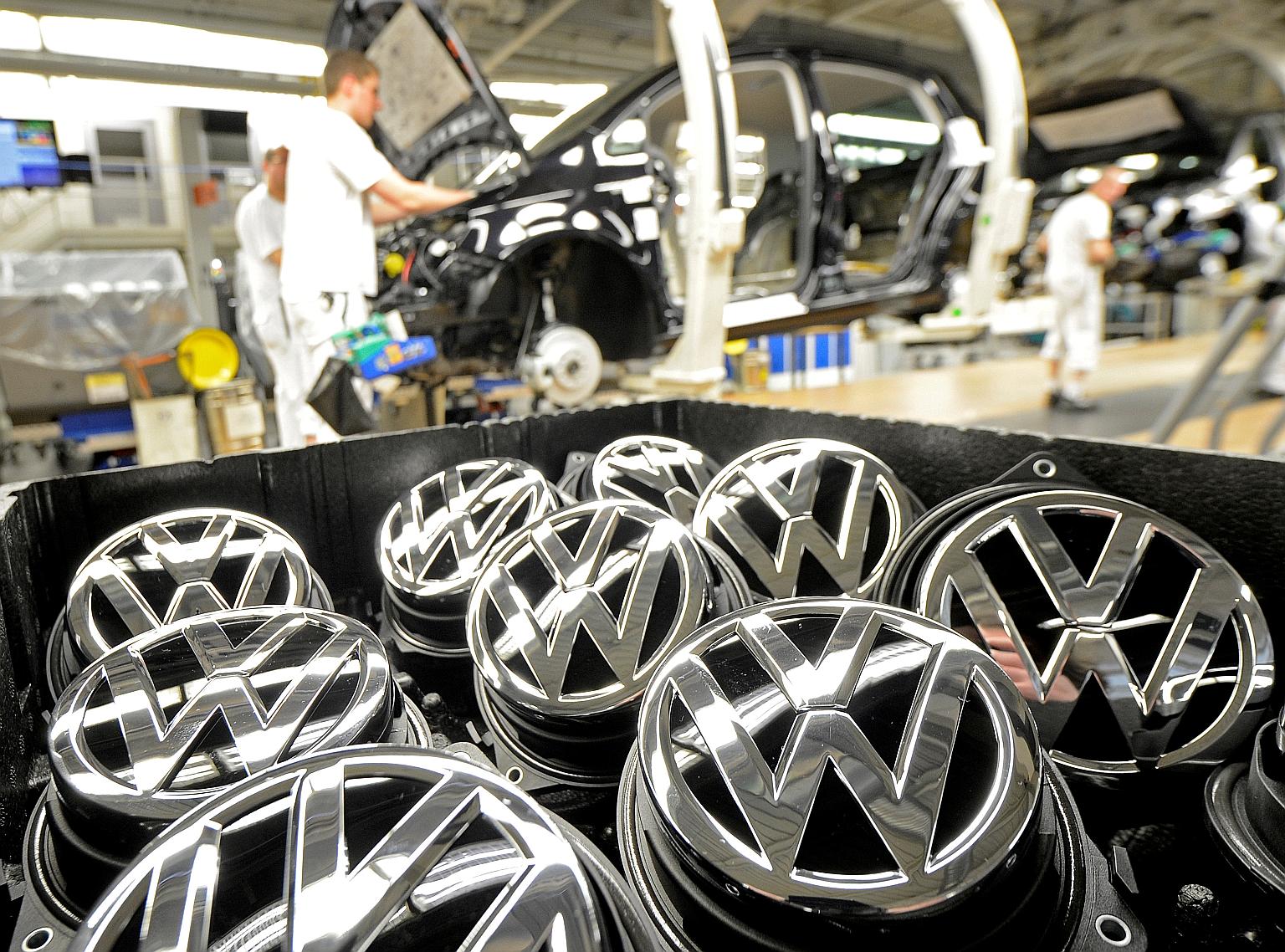 Emblems of the Volkswagen Golf VII car in a production line at a plant in Wolfsburg, Germany. Some 11 million Volkswagen vehicles worldwide were affected by the emissions scandal that broke in October last year.