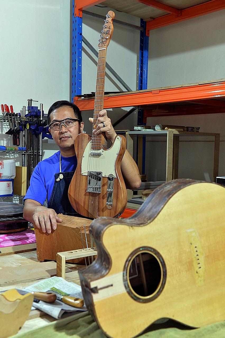 Mr Chan with the electric guitar he made from a 25m-tall Senegal mahogany tree that once stood next to the F1 Pit Building at Marina Promenade. The tree-lover feels that having a "tangible" and "cool" object will help spread the conservation message