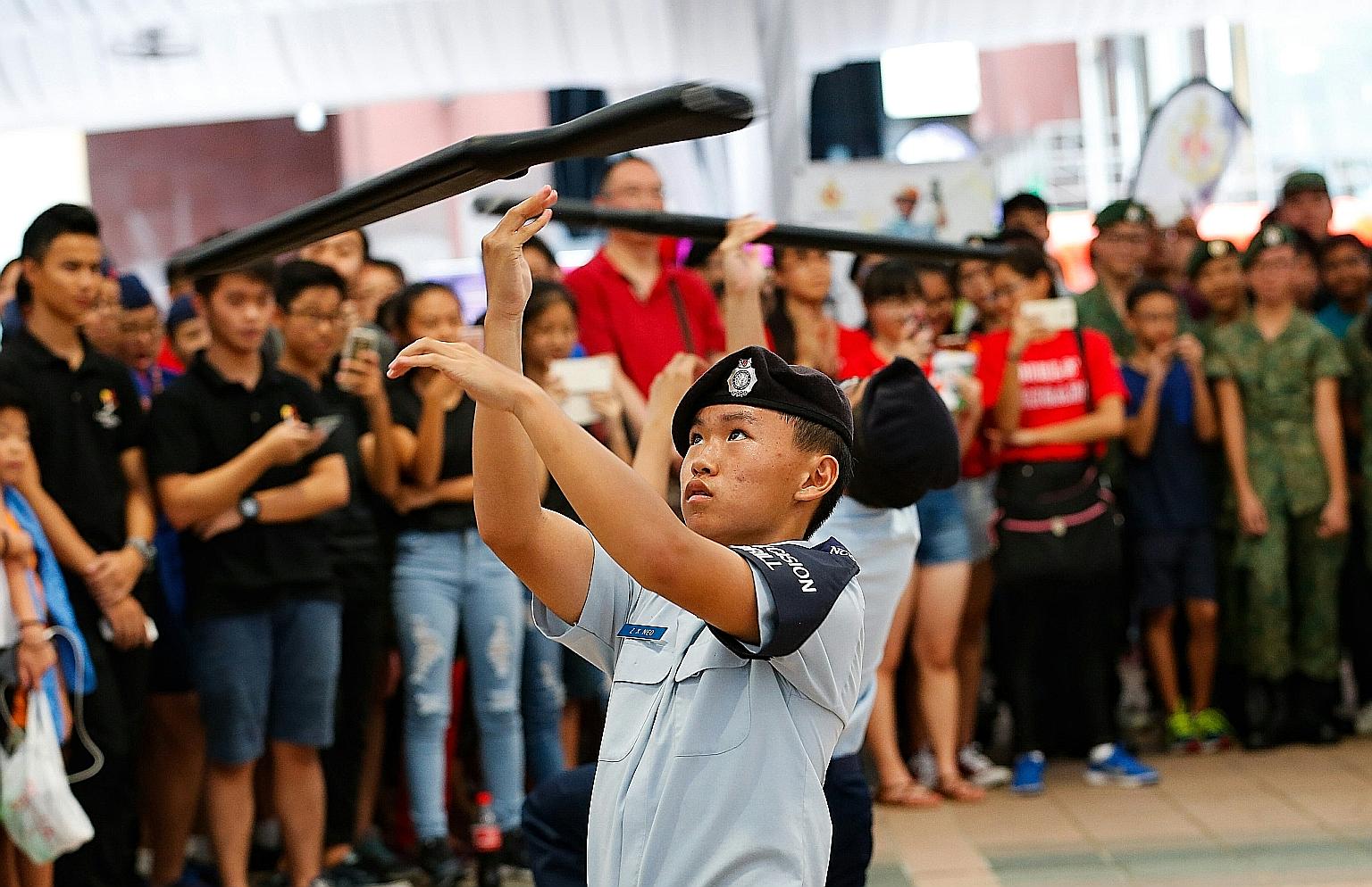 Catholic High School students performing a precision drill with wooden rifle replicas at the Uniformed Groups Carnival yesterday.