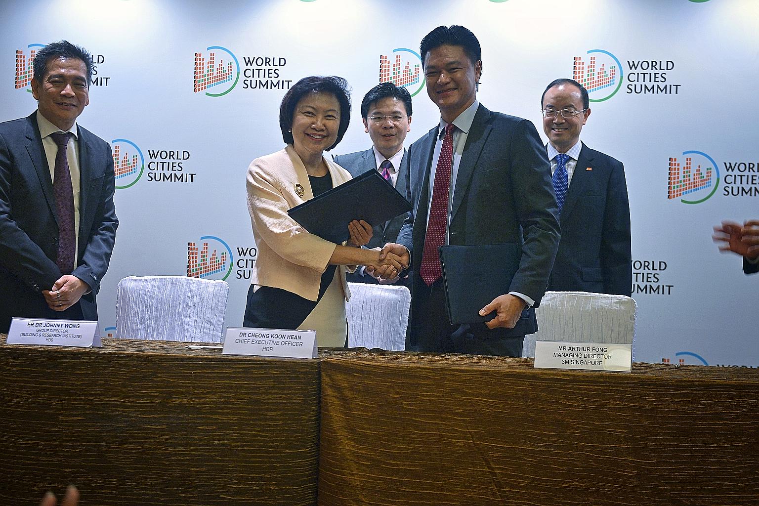 National Development Minister Lawrence Wong (centre) witnessing the sealing of the pact by HDB chief executive Cheong Koon Hean and 3M Singapore managing director Arthur Fong. Beside them are HDB's Building and Research Institute group director Johnn
