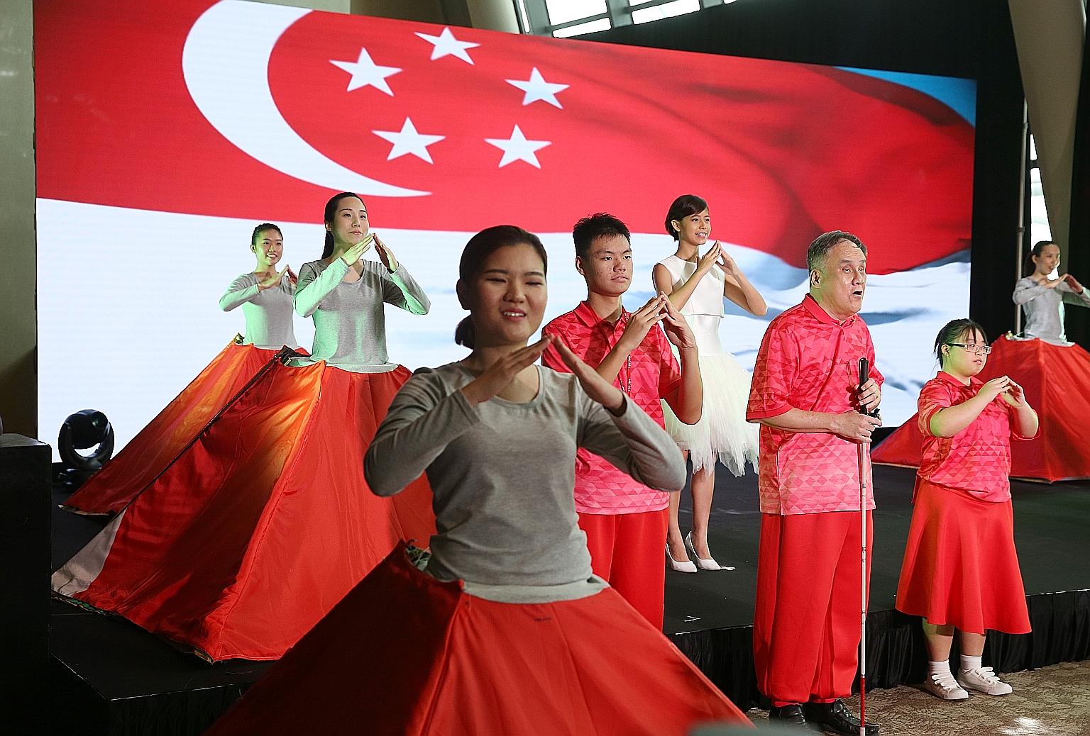 Special needs participants and Singapore Soka Association performers singing the song Home at a media preview. The Aug 9 event will have, for the first time, "song signing". Led by sign language instructor Neoh Yew Kim, the audience will be invited t