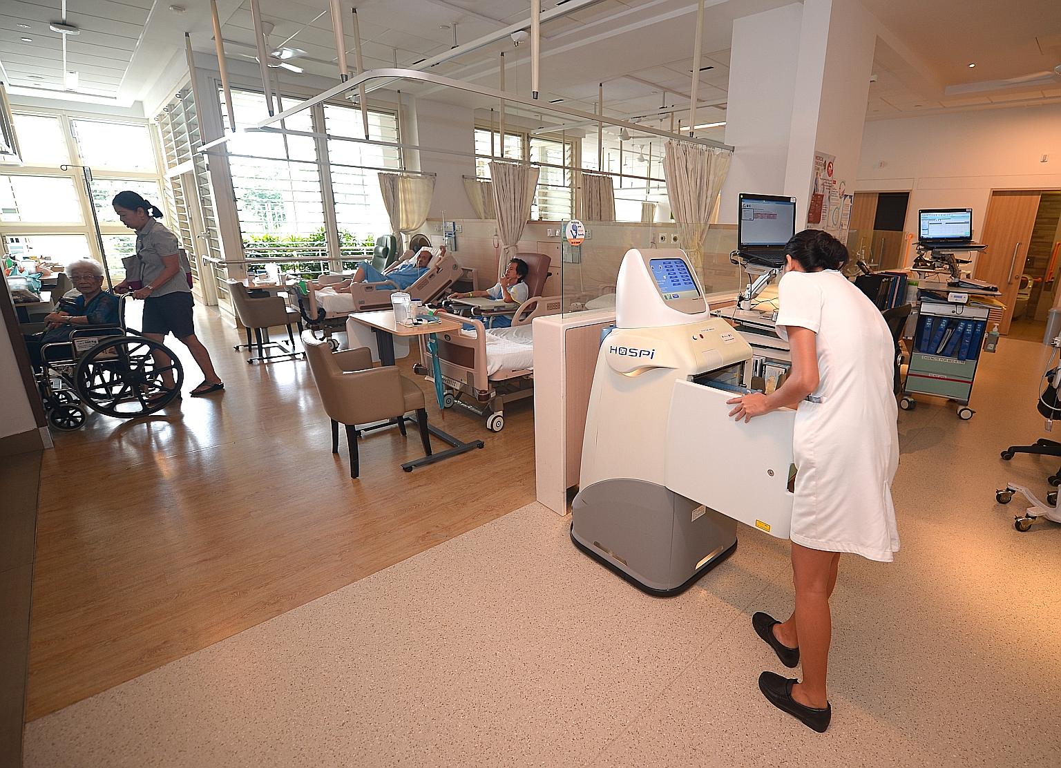 A Changi General Hospital nurse collecting documents delivered by robots called Hospi. Mr Iswaran says the Government's role is to find the right intersect between important initiatives and sectors that are "most ripe for activity", and optimise reso